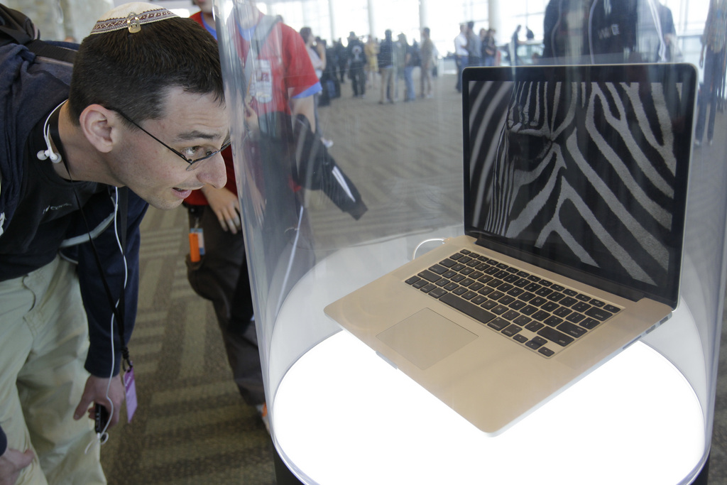 Attendee looks  at the new MacBook Pro on display Apple Developers Conference in San Francisco, Monday, June 11, 2012. (AP Photo/Paul Sakuma)