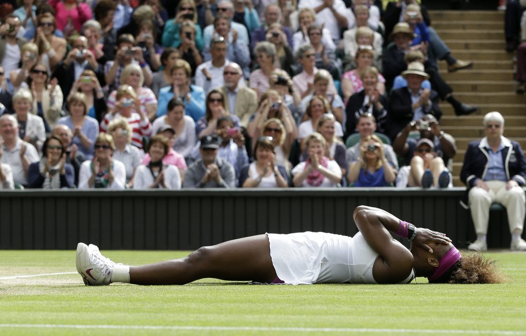 Serena Williams of the United States reacts after defeating Agnieszka Radwanska of Poland to win the women's final match at the All England Lawn Tennis Championships at Wimbledon, England, Saturday, July 7, 2012. (AP Photo/Kirsty Wigglesworth)