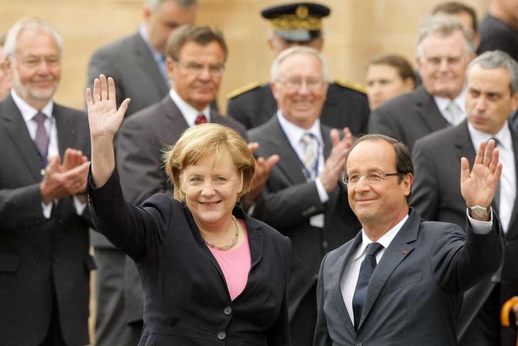 German Chancellor Angela Merkel, and French President Francois Hollande arrive in front of the Reims cathedral in Reims, eastern France, Sunday July 8, 2012. Leaders of France and Germany meet to mark 50 years of an important step toward cooperation after two world wars, amid today's tensions over Europe's financial crisis. (AP Photo/Michel Spingler)