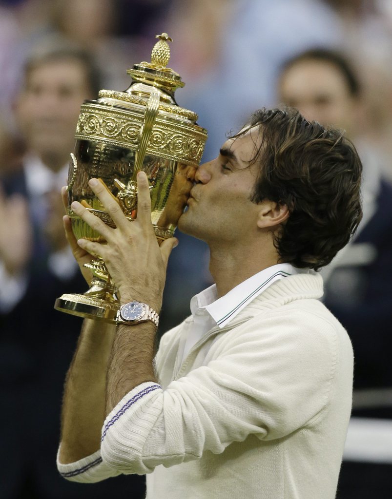 Roger Federer of Switzerland celebrates with the trophy after winning the men's singles final against Andy Murray of Britain at the All England Lawn Tennis Championships at Wimbledon, England, Sunday, July 8, 2012. (AP Photo/Anja Niedringhaus)