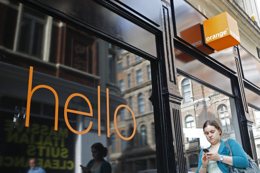 A woman walks by a branch of Orange mobile phone shop in the City of London, Tuesday, Sept. 8, 2009. Deutsche Telekom AG and France Telecom SA said Tuesday they intend to combine their British mobile phone units _ T-Mobile UK and Orange UK _ to form the country's biggest mobile operator. (AP Photo/Sang Tan)