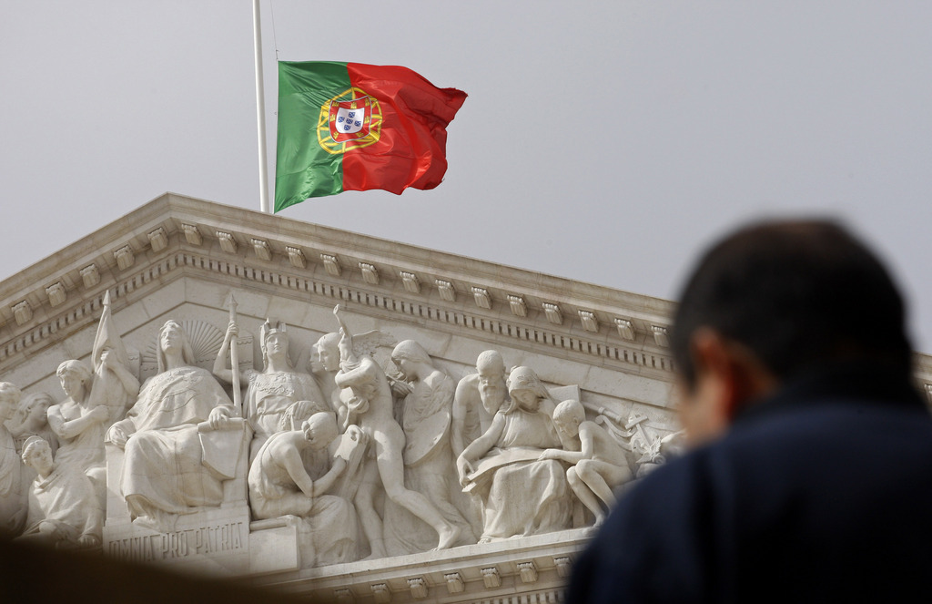 A Portuguese flag flies at half staff at the national assembly in Lisbon on Monday, Feb. 22, 2010. The Portuguese government has declared three days of national mourning following the floods that have hit Madeira island, killing  at least 42 people. (AP Photo/Francisco Seco)