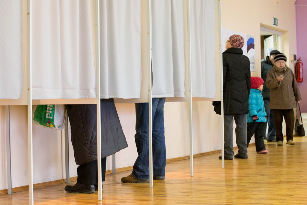 People fill their ballot papers in voting booths at a polling station in Tallinn, Estonia, on Sunday, March 1, 2015. Estonians are voting for a new Parliament in an election dominated by economic issues and security concerns due to tension  in Ukraine. (AP Photo/Liis Treimann)