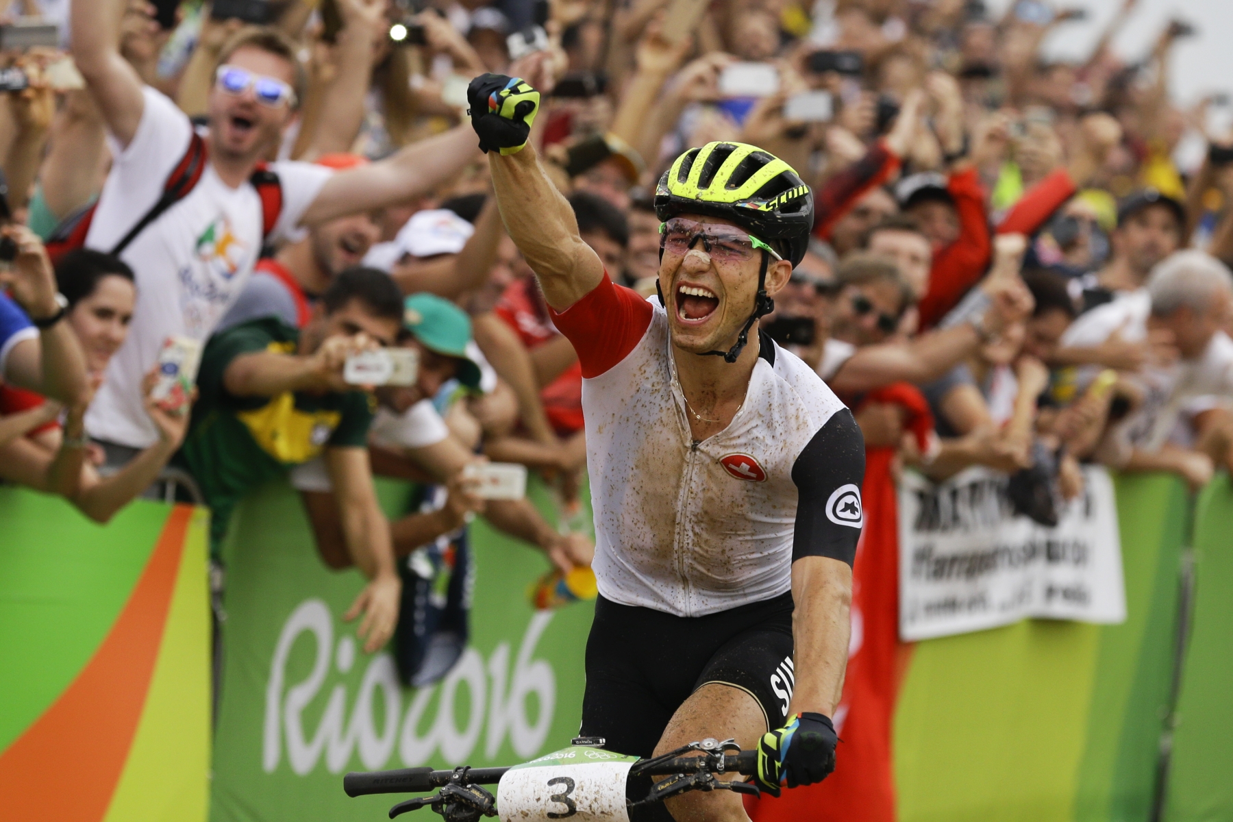 Nino Schurter of Switzerland celebrates after finishing first on the men's cross-country cycling mountain bike race at the 2016 Summer Olympics in Rio de Janeiro, Brazil, Saturday, Aug. 20, 2016. (AP Photo/Victor R. Caivano)