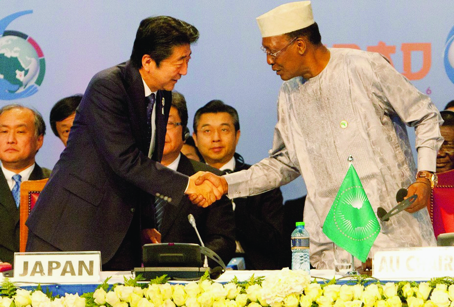 Japanese Prime Minister Shinzo Abe, left, shakes hands with Chad's President Idriss Deby during the opening of Tokyo International Conference on African Development (TICAD) at the Kenyatta International Conference Centre in Nairobi, Kenya, Saturday, Aug. 27, 2016. (AP Photo/Sayyid Abdul Azim) Kenya Japan TICAD