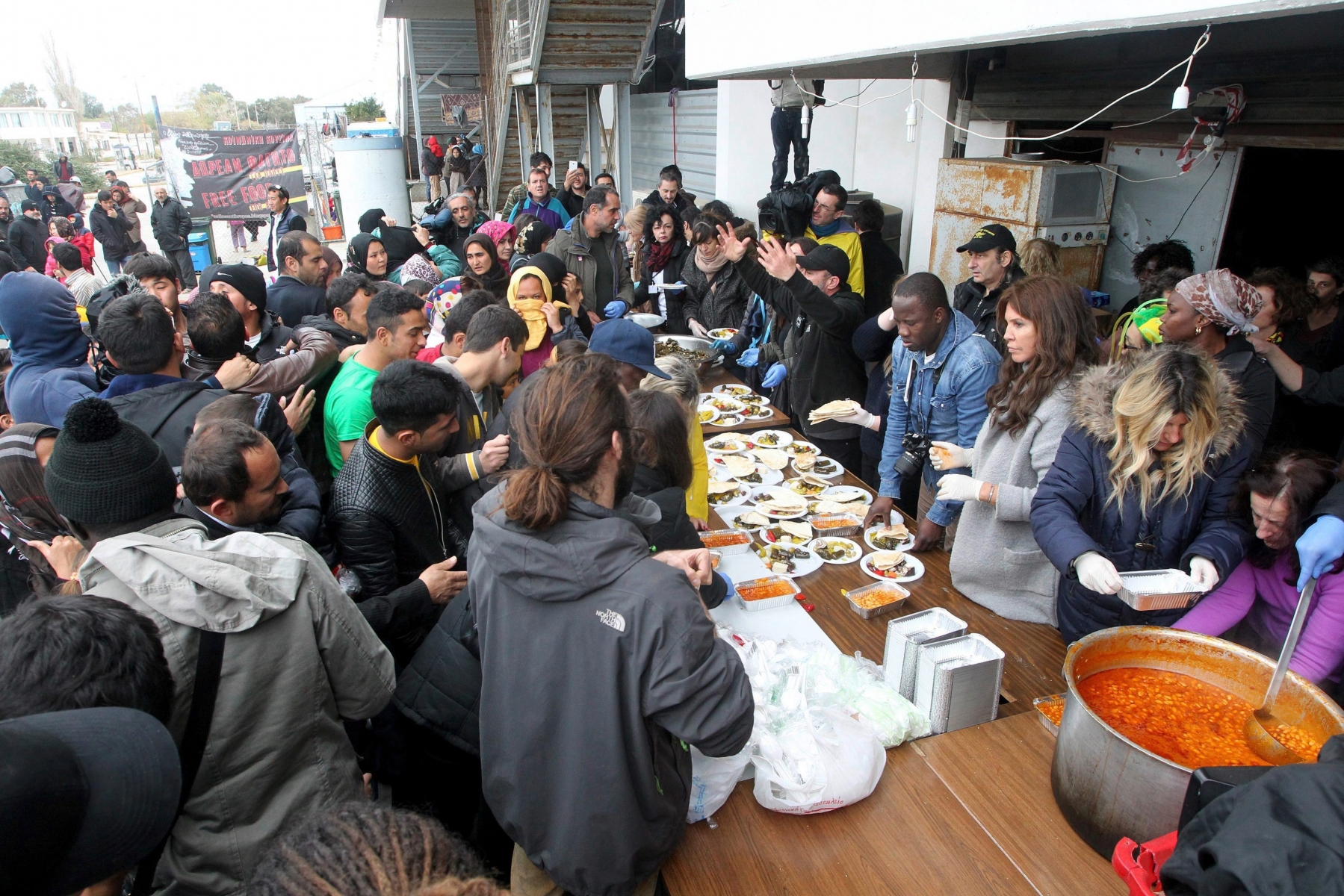 epa05211263 Refugees line up to receive food supplied by humanitarian aid groups at the former west airport terminal in Elliniko, Greece, 14 March 2016. Hundreds of migrants stuck at the closed Greek-Macedonian border have left the camp to seek other ways to enter Macedonia. Greece has registered in its territory more of 44,000 migrants trapped due to entry restrictions already imposed by Macedonia in recent months, by denying entry to all those who are considered economic migrants, prohibiting the passage of Afghans, and finally denying entry to all Syrians and Iraqis who are not from combat areas.  EPA/PANTELIS SAITAS GREECE MIGRATION REFUGEES