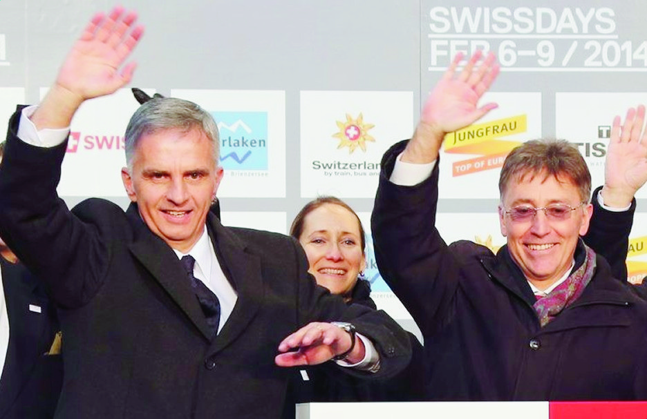 Swiss Federal President Didier Burkhalter, second left, and his wife, Friedrun Sabine Burkhalter, right, wave with Japan's Vice-Ministers for Foreign Affairs Takao Makino, left, Swiss Ambassador to Japan Urs Bucher, third right, and other participants during the opening ceremony of the Feb. 7-9 Swissdays event marking the 150th anniversary of diplomatic relations between Switzerland and Japan in Tokyo Thursday, Feb. 6, 2014. (AP Photo/Koji Sasahara) JAPAN BESUCH SCHWEIZ