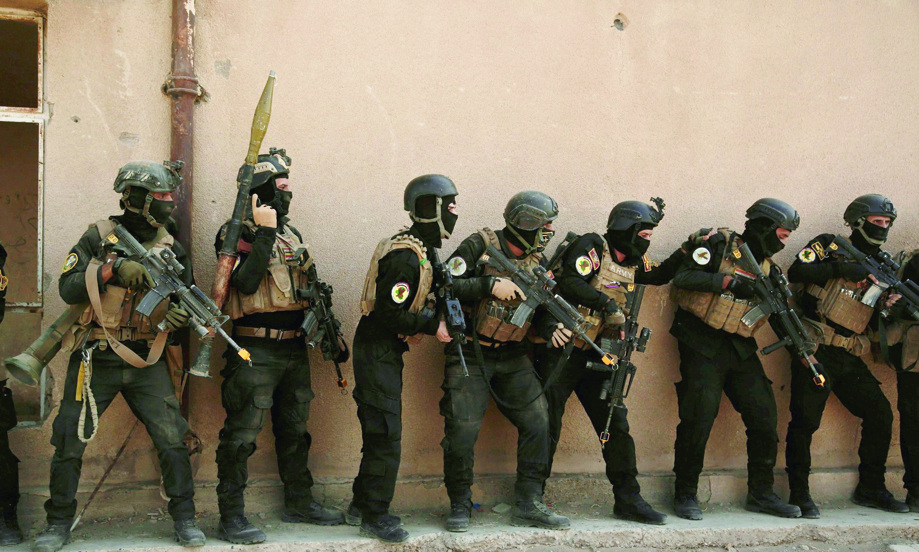 FILE - In this Saturday, Aug. 13, 2016 file photo, soldiers from the 1st Battalion of the Iraqi Special Operations Forces are stacked against a building during a training exercise to prepare for the operation to re-take Mosul from Islamic State militants, in Baghdad, Iraq. The disparate groups that make up Iraq's security forces are converging on the city of Mosul, lining up for a battle on the historic plains of northern Iraq that is likely to be decisive in the war against the Islamic State group. (AP Photo/Maya Alleruzzo, File) Mideast Iraq Battle For Mosul