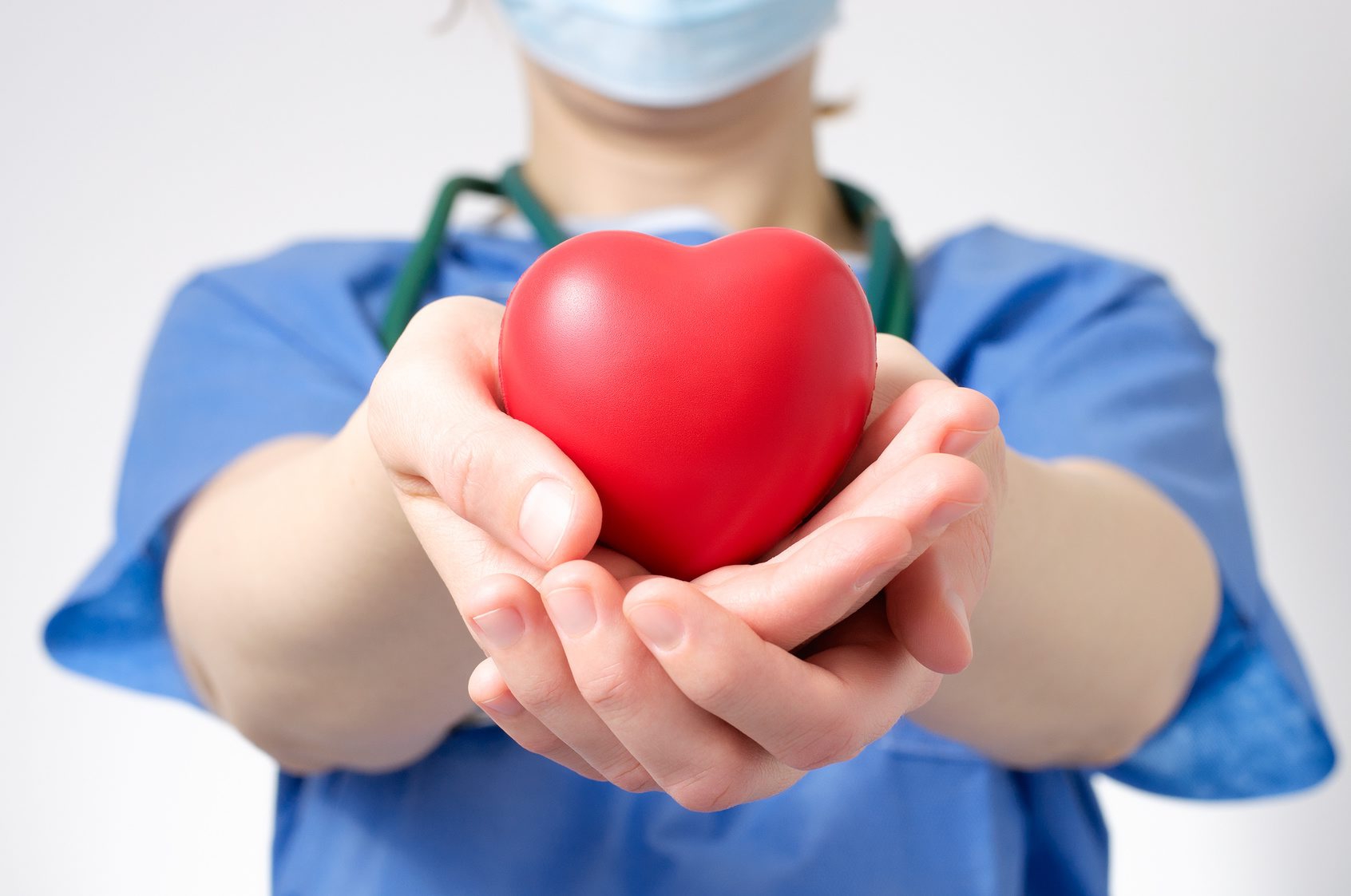 Female doctor holding a red heart shape Doctor holding a heart