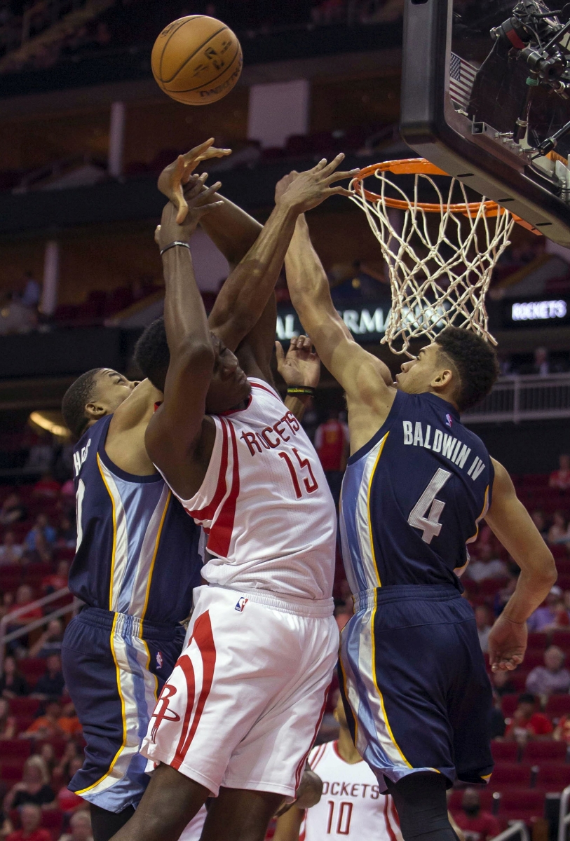 Houston Rockets center Clint Capela (15) battles Memphis Grizzlies' D.J. Stephens and Wade Baldwin IV for a rebound in the first half of a preseason NBA basketball game Saturday, Oct. 15, 2016, in Houston. (AP Photo/Richard Carson)