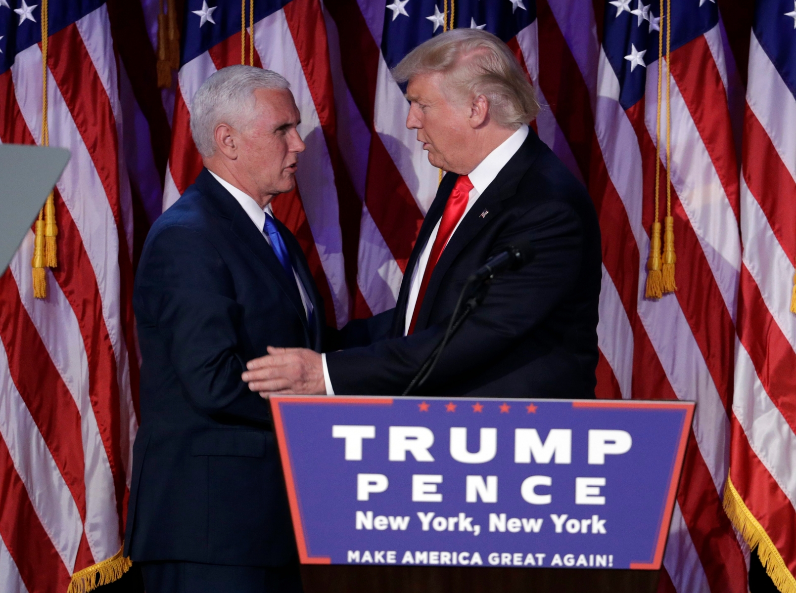 President-elect Donald Trump, right, shakes hands with Vice-President-elect Mike Pence during his election night rally, Wednesday, Nov. 9, 2016, in New York. (AP Photo/John Locher) 2016 Election Trump