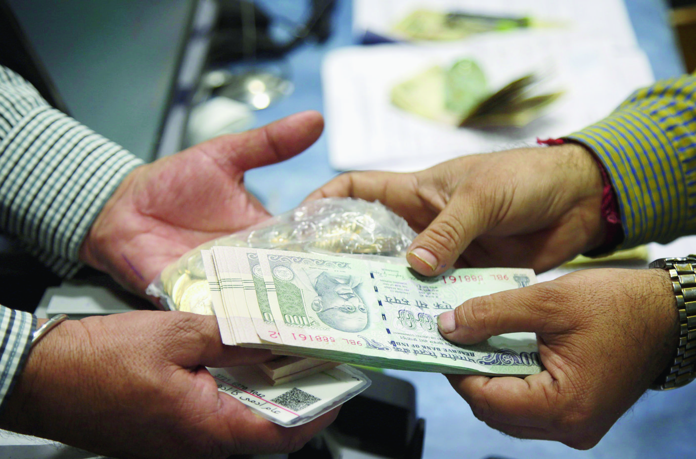 epa05625129 An Indian man exchanges Indian rupee notes at a bank in Jammu, the winter capital of Kashmir, India, 10 November 2016. In a major decision, Indian Prime Minister, in an address to the nation has stated that currency notes with denomination values of INR 500 (about 7.5 US dollars) and INR 1000 (about 15 US dollars) respectively will be invalid and will be discontinued from midnight of 08 November 2016. Indian government also introduced the new notes of INR 500 (about 7.5 US dollars) and INR 2000 (about 30 US dollars) and citizens would be allowed to exchange their old currency notes through the banks and post offices till 30 December 2016. This is being considered as a major step towards curbing the problem of black money.  EPA/JAIPAL SINGH INDIA HIGH DENOMINATION VALUES CURRENCY REFORMS