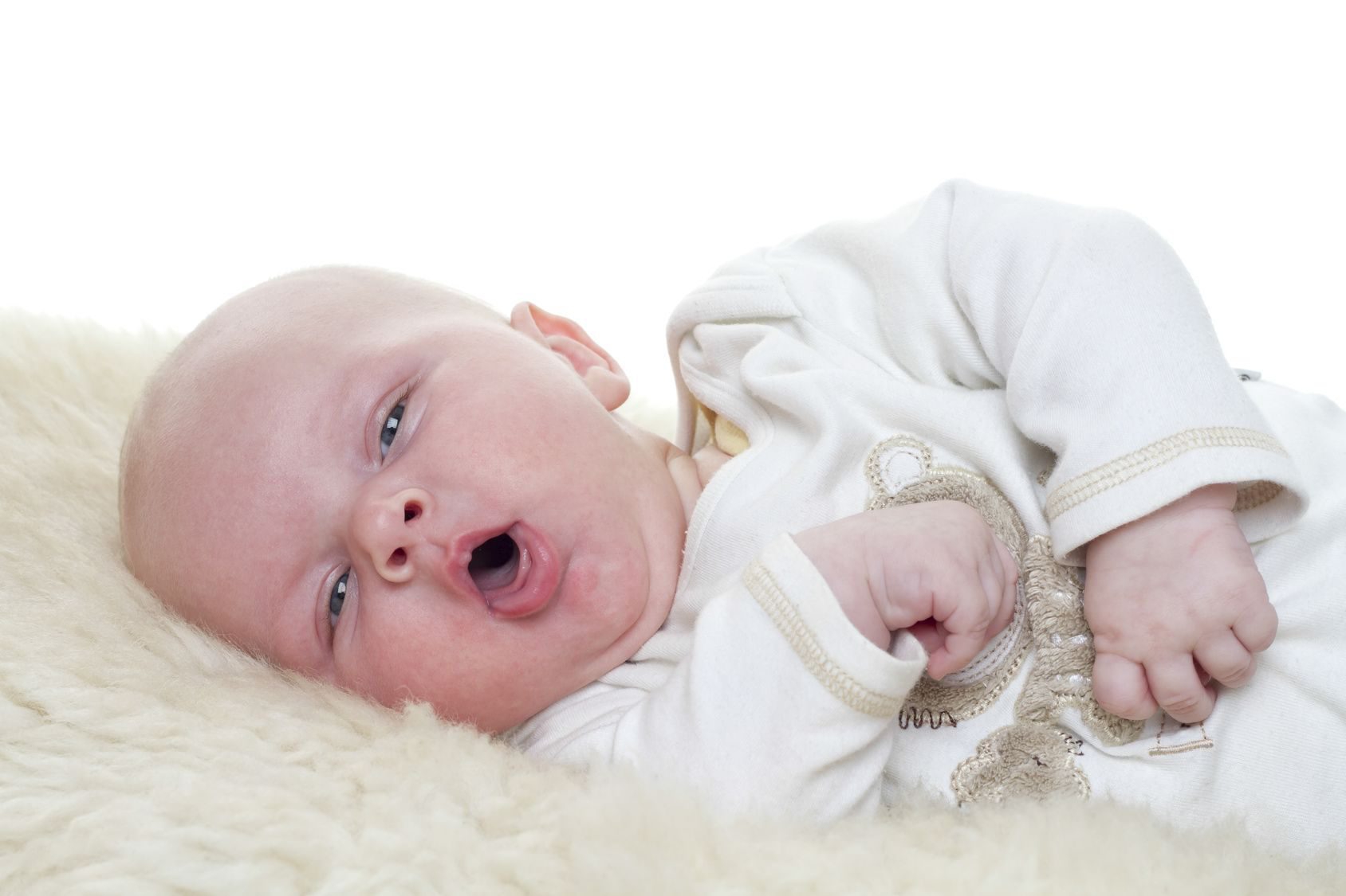 Baby on a sheepskin. Baby is three month old. Studiolight with white background Baby on a sheepskin. Baby is three month old. Studiolight with white background