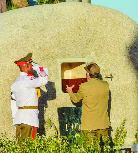 Cuba's President Raul Castro places the ashes of his older brother Fidel Castro into a niche in his tomb, a simple, grey, round stone about 15 feet high at the Santa Ifigenia cemetery in Santiago, Cuba, Sunday Dec.4, 2016. The niche was then covered by a plaque bearing the single name,"Fidel."(Marcelino Vazquez Hernandez/Pool Photo via AP) Cuba Fidel Castro