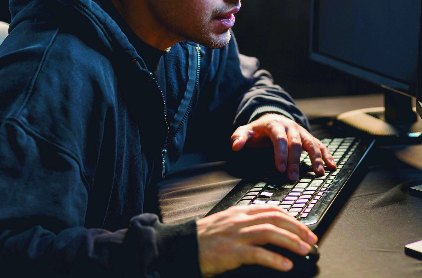 Close-up of hacker writing on computer keyboard Close-up of keyboard