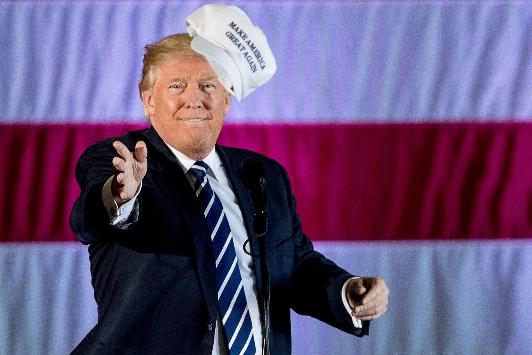 President-elect Donald Trump throws a hat into the audience while speaking at a rally in a DOW Chemical Hanger at Baton Rouge Metropolitan Airport, Friday, Dec. 9, 2016, in Baton Rouge, La. (AP Photo/Andrew Harnik) Trump