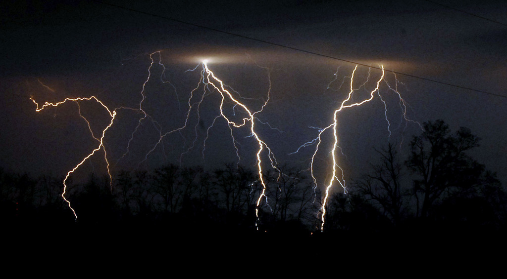 Lightning in shown in the sky over near Maysville, Ky., early Wednesday, March 28, 2007, as thunderstorms moved through Mason County, Ky. (AP Photo/The Ledger Independent, Terry Prather)