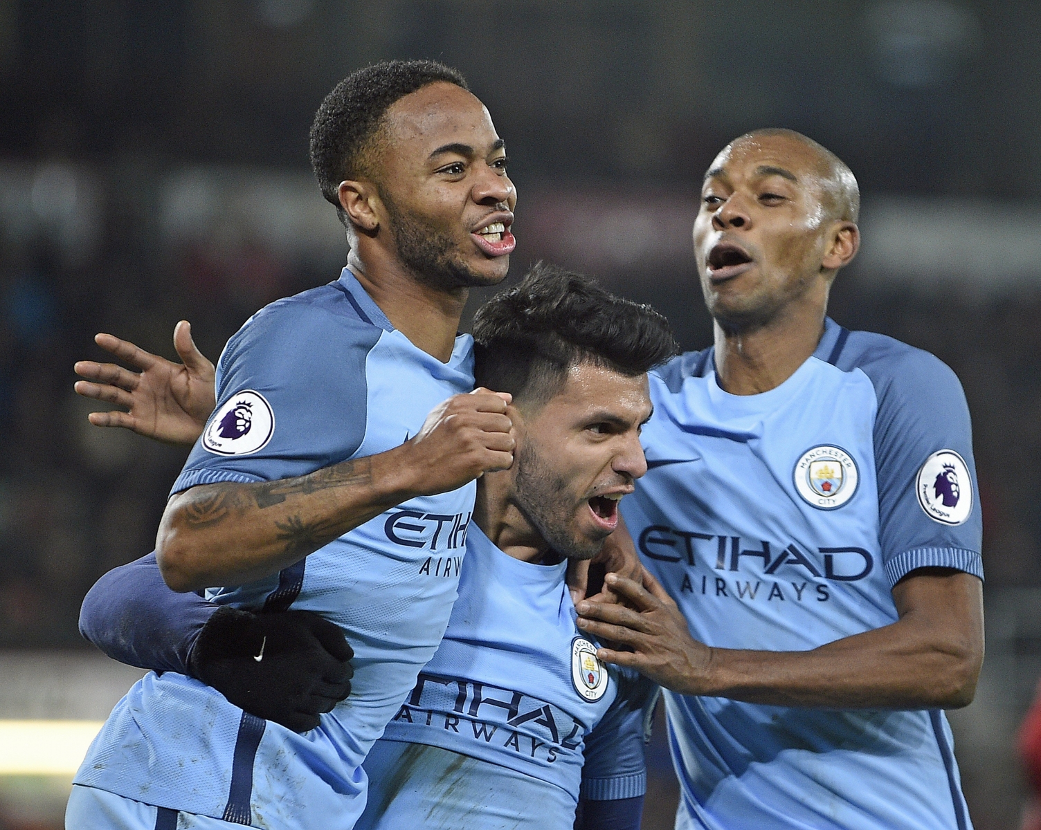 epa05791725 (L-R) Manchester City's Raheem Sterling, Sergio Aguero and Fernadinho celebrate the 2-0 lead during the English Premier League soccer match between AFC Bournemouth and Manchester City at the Vitalitiy stadium, Bournemouth, Britain, 13 February 2017.  EPA/GERRY PENNY EDITORIAL USE ONLY. No use with unauthorized audio, video, data, fixture lists, club/league logos or 'live' services. Online in-match use limited to 75 images, no video emulation. No use in betting, games or single club/league/player publications.