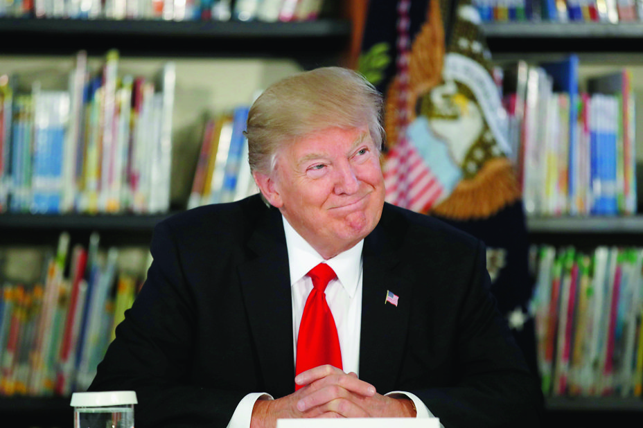 President Donald Trump smiles as he participates in a round table discussion during a tour of Saint Andrew Catholic School, Friday, March 3, 2017, in Orlando, Fla. (AP Photo/Alex Brandon) Trump
