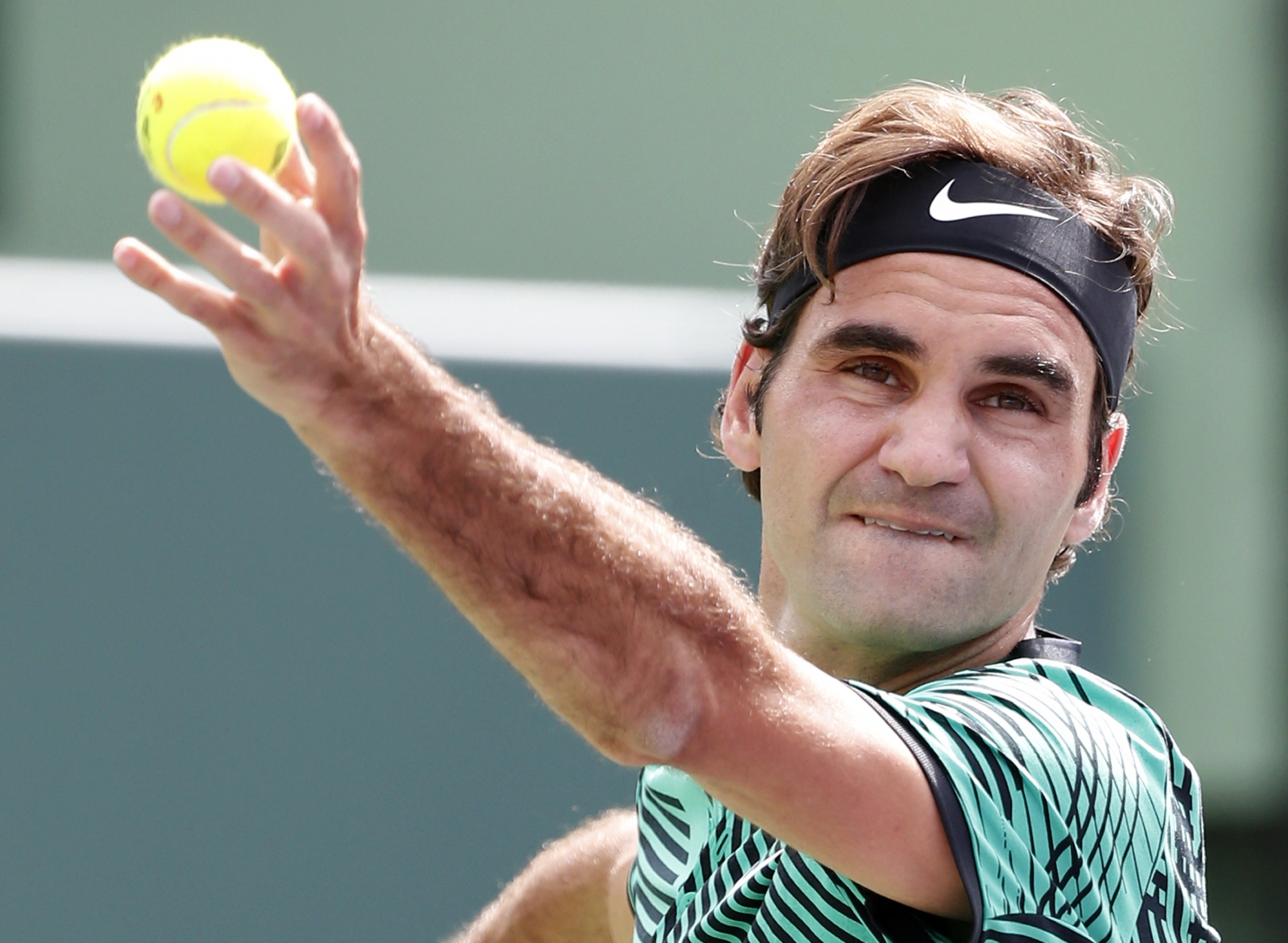 Roger Federer, of Switzerland, tosses the ball to serve to Frances Tiafoe during a tennis match at the Miami Open, Saturday, March 25, 2017 in Key Biscayne, Fla. (AP Photo/Wilfredo Lee)