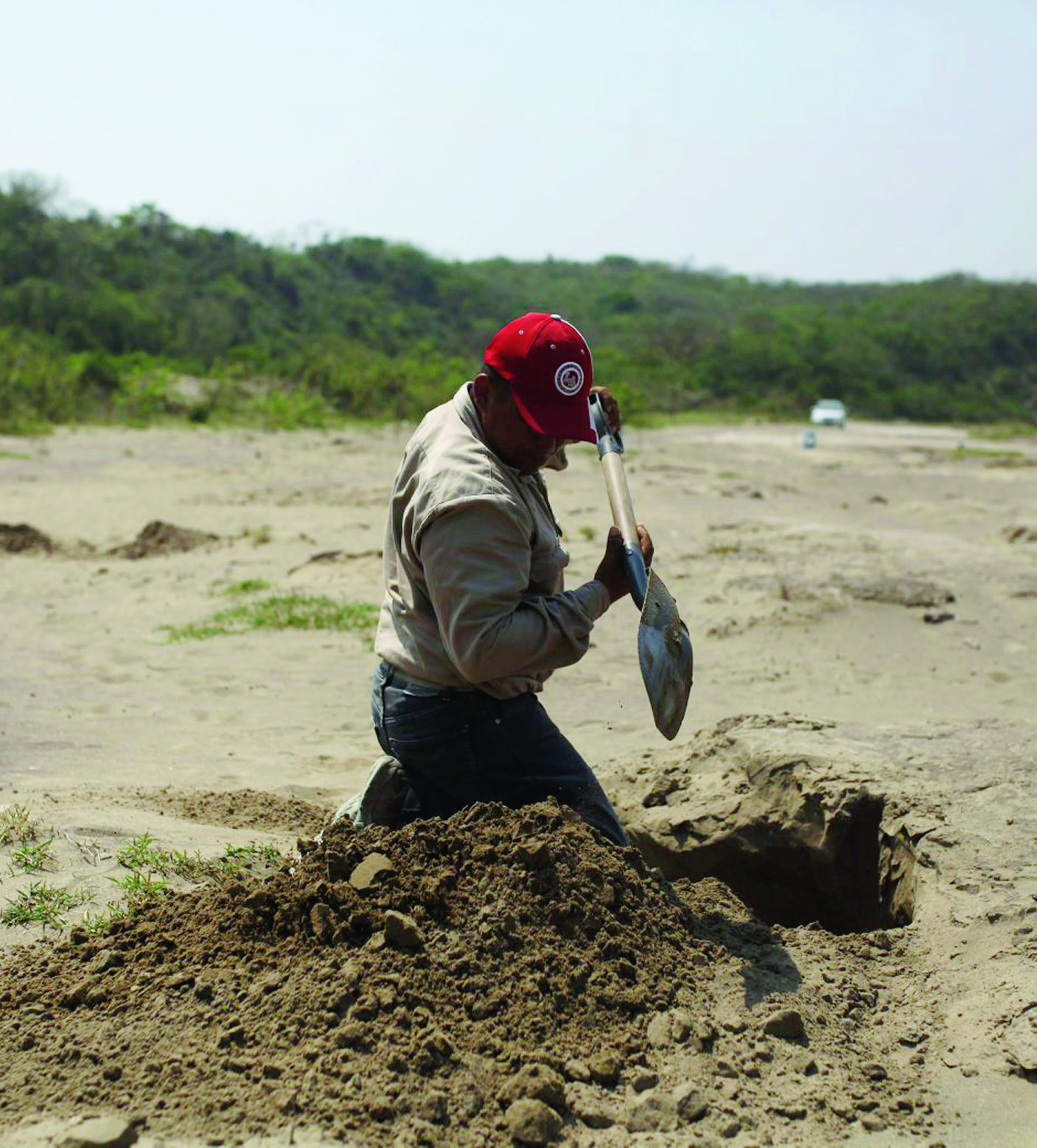 A volunteer searcher digs into the earth at a clandestine grave site in Colinas de Santa Fe, in Mexico's Veracruz state, Thursday, March 30, 2017. The searchers from Colectivo Solecito, who have so far found 253 sets of remains, redoubled their efforts after receiving a tip that hundreds more bodies may be buried there. (AP Photo/Felix Marquez) Mexico Clandestine Graves