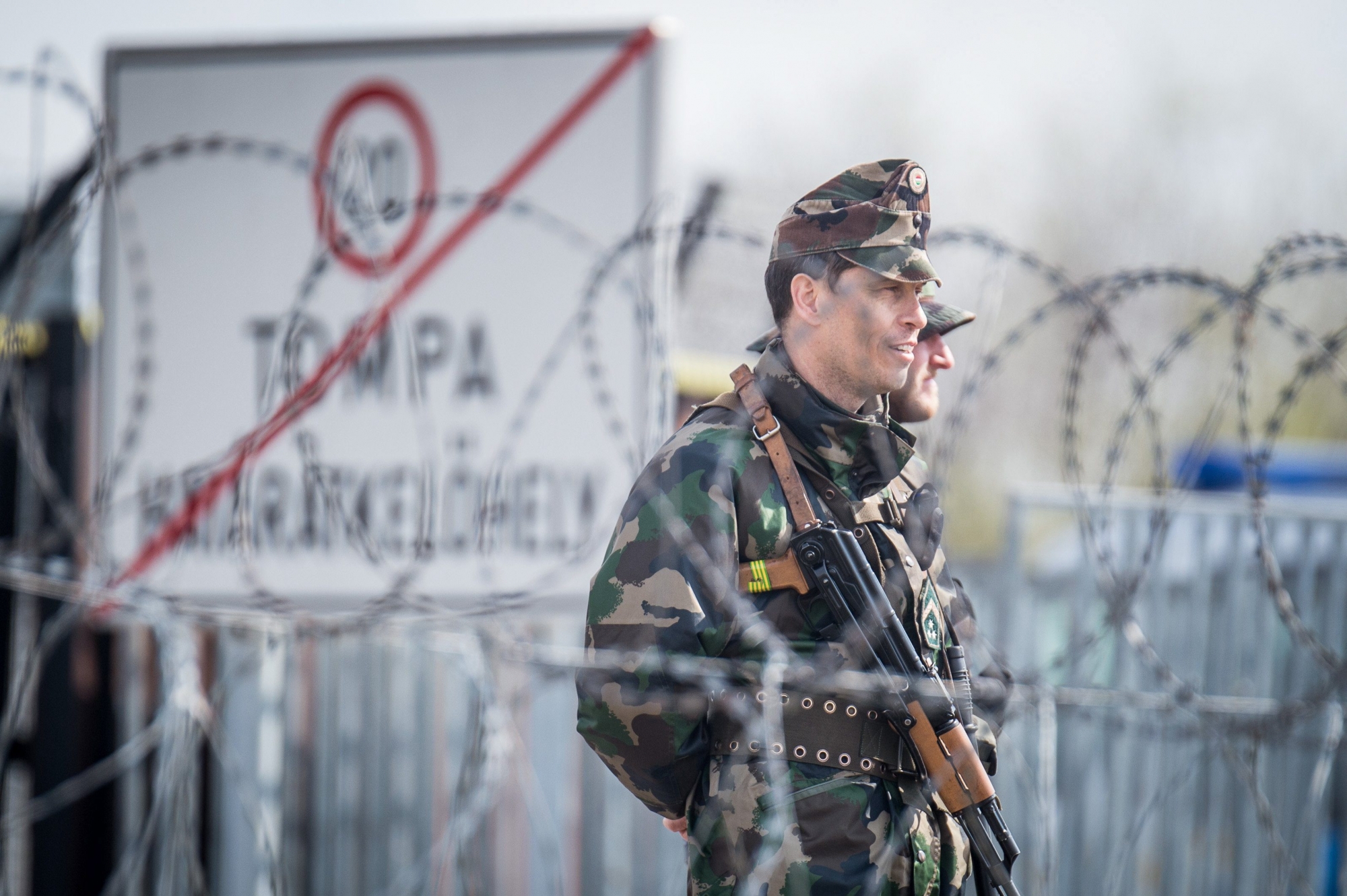 epa05891795 A Hungarian police officer patrols the enlarged barbed wire transit zone set up for migrants at the Hungary's southern border with Serbia near Tompa, 169 kms southeast of Budapest, Hungary, 06 April 2017. The complex is one of two new detention centers for asylum seekers in the Hungarian transit zone and contains shipping containers that are used to automatically detain migrants in the transit zone while their claims are investigated.  EPA/SANDOR UJVARI HUNGARY OUT HUNGARY MIGRATION