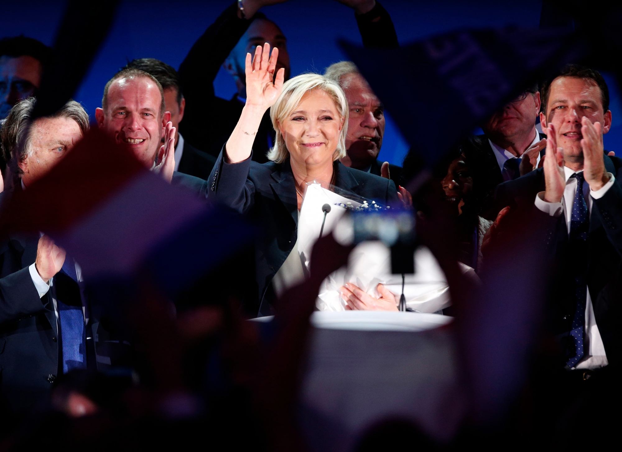 Far-right leader and candidate for the 2017 French presidential election, Marine Le Pen, waves to supporters after exit poll results of the first round of the presidential election were announced at her election day headquarters in Henin-Beaumont, northern France, Sunday, April 23, 2017. Polling agency projections show far-right leader Marine Le Pen and centrist Emmanuel Macron leading in the first-round French presidential election. (AP Photo/Michel Spingler) France Election