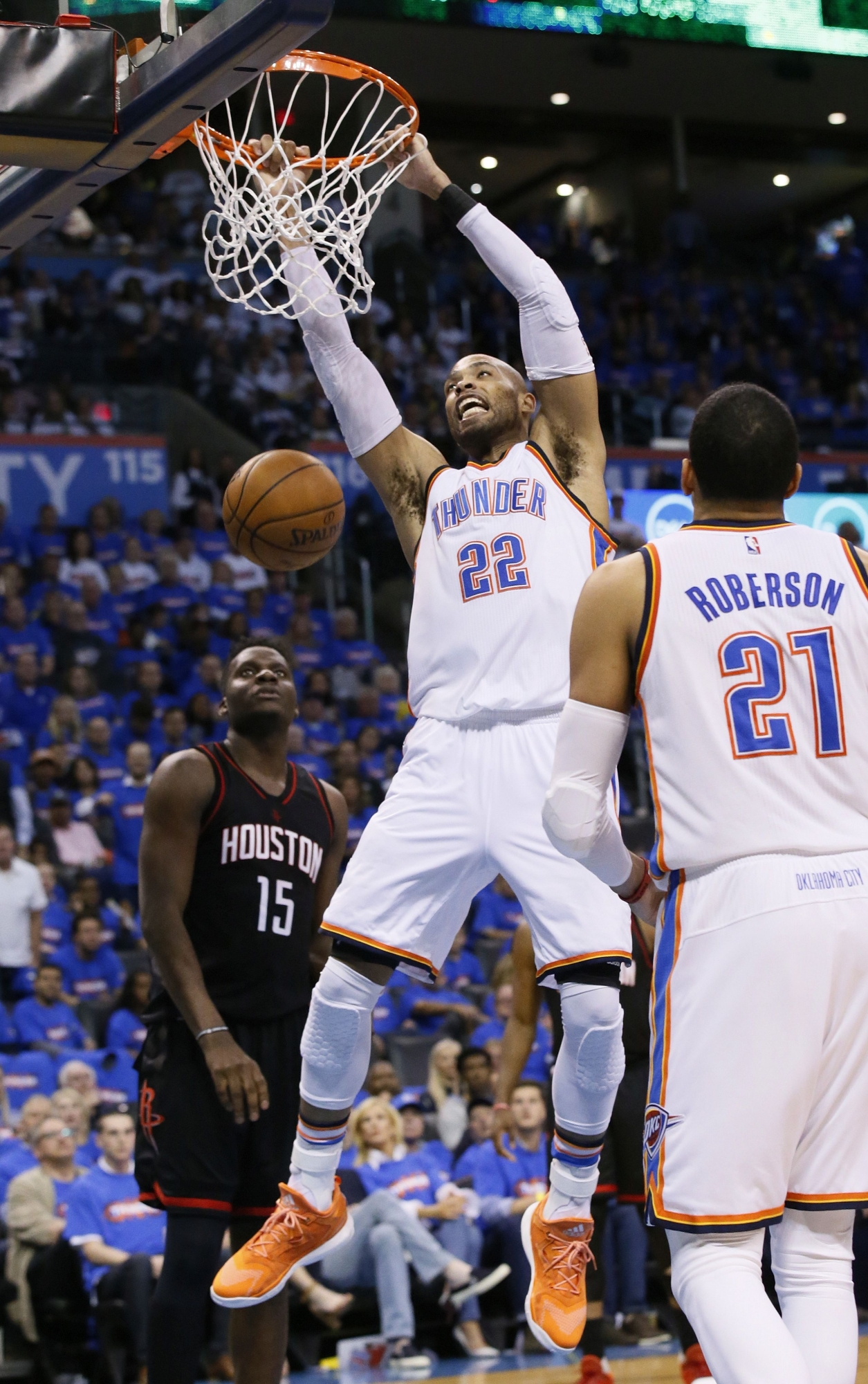 Oklahoma City Thunder forward Taj Gibson (22) dunks in front of Houston Rockets center Clint Capela (15) in the third quarter of Game 3 of a first-round NBA basketball playoff series in Oklahoma City, Friday, April 21, 2017. The move to get 6-foot-9 Gibson is paying dividends and has helped the Thunder get back in the series against the Rockets. (AP Photo/Sue Ogrocki)