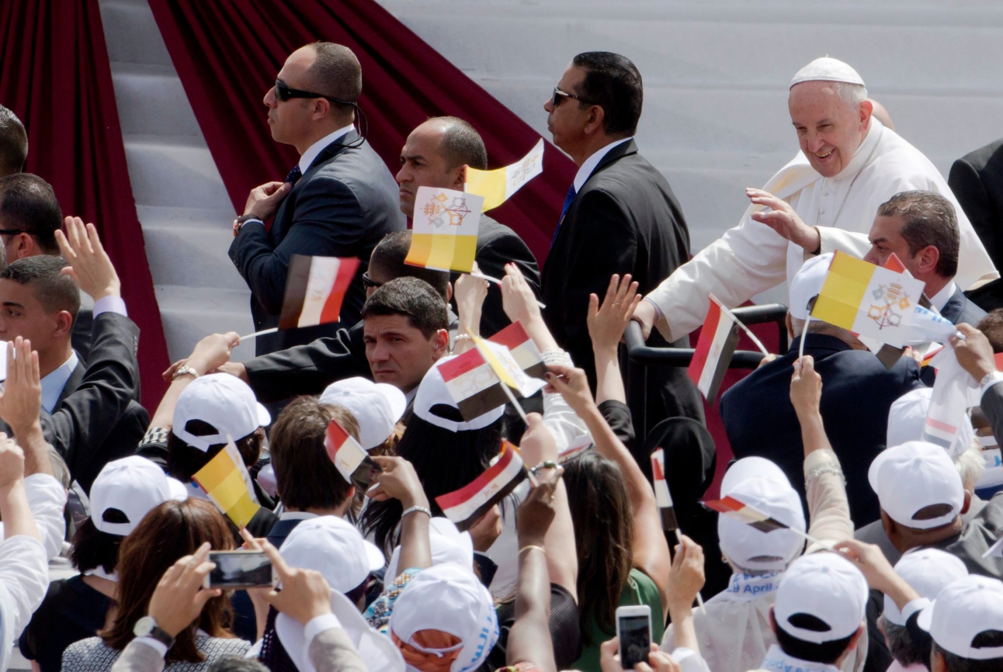 Pope Francis waves as he arrives to celebrate Mass for Egypt's tiny Catholic community, at the Air Defense Stadium in Cairo, Saturday, April 29, 2017. Pope Francis came to Egypt on Friday for a historic visit to the Arab and Muslim majority nation aimed at presenting a united Christian-Muslim front to repudiate violence committed in God's name.(AP Photo/Amr Nabil) Egypt Pope