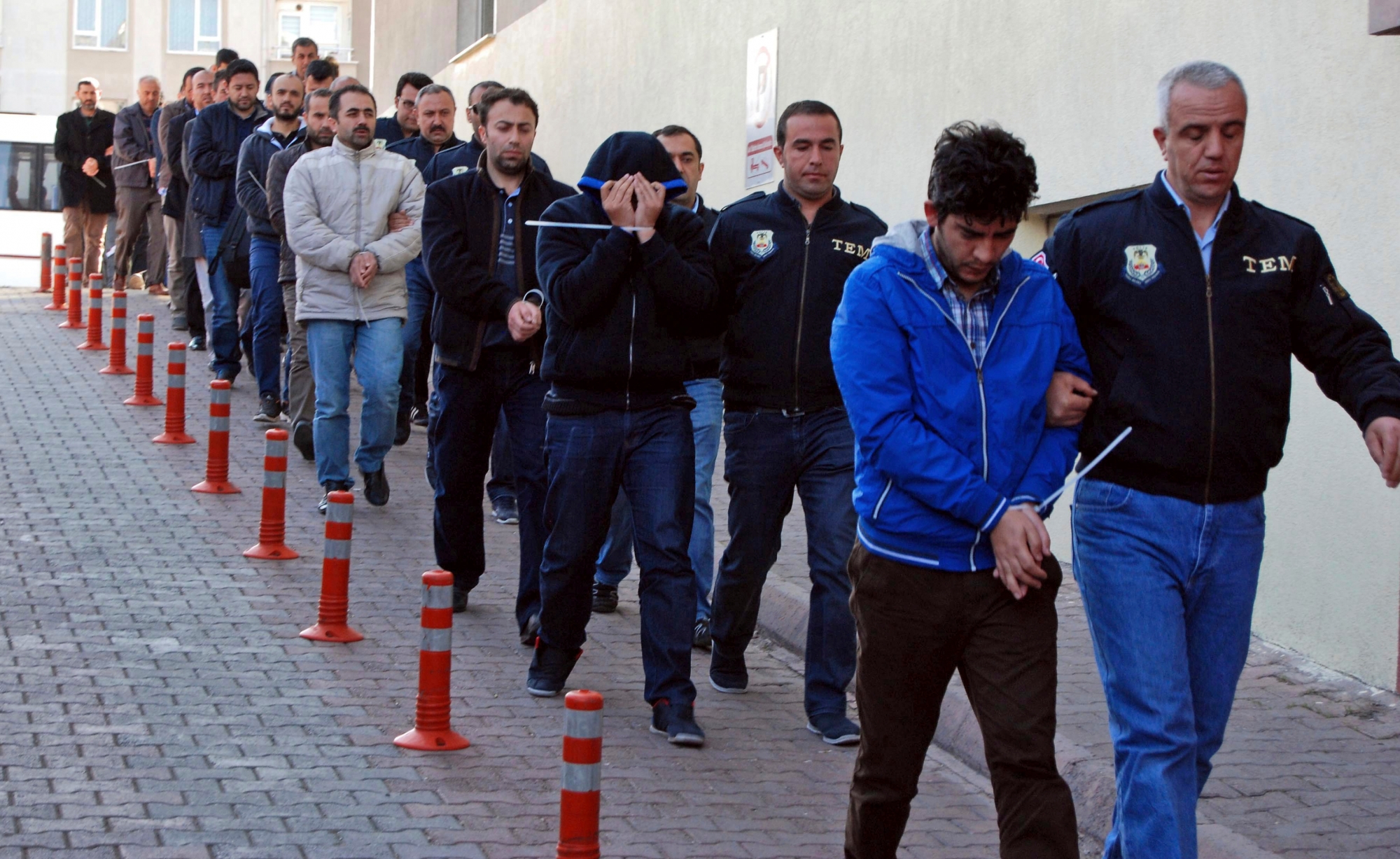 Police officers escort people, arrested because of suspected links to U.S.-based cleric Fethullah Gulen, in Kayseri, Turkey, Wednesday, April 26, 2017. Police launched simultaneous operations across the country on Wednesday, detaining hundreds of people with suspected links to U.S.-based cleric Fethullah Gulen. The suspects are allegedly Gulen operatives who directed followers within the police force. (Olay Duzgun/DHA-Depo Photos via AP) Turkey Failed Coup