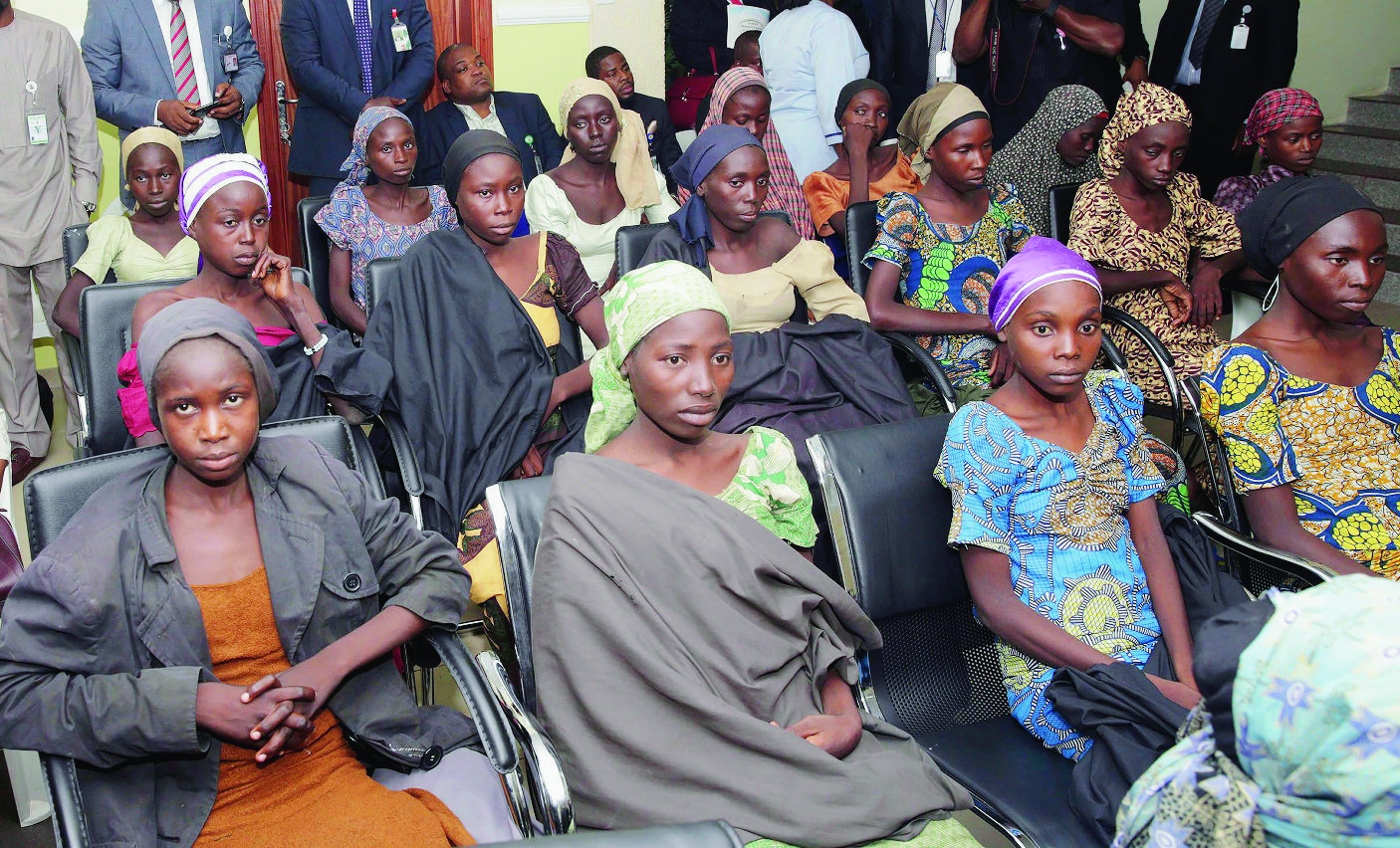 FILE - In this Thursday, Oct. 13, 2016 file photo released by the Nigeria State House, Chibok schoolgirls recently freed from Islamic extremist captivity are seen during a meeting with Nigeria's Vice President Yemi Osinbajo in Abuja, Nigeria. Large numbers of Chibok schoolgirls seized three years ago by Boko Haram have been freed in exchange for detained suspects with the extremist group, Nigeria's government announced early Sunday, May 7, 2017 in the largest release negotiated yet in the battle to save nearly 300 girls whose mass abduction exposed the mounting threat posed by the Islamic State-linked fighters. After the initial release of 21 Chibok girls in October, the government denied making an exchange or paying ransom. (Sunday Aghaeze/Nigeria State House via AP, File) Nigeria Kidnapped Schoolgirls