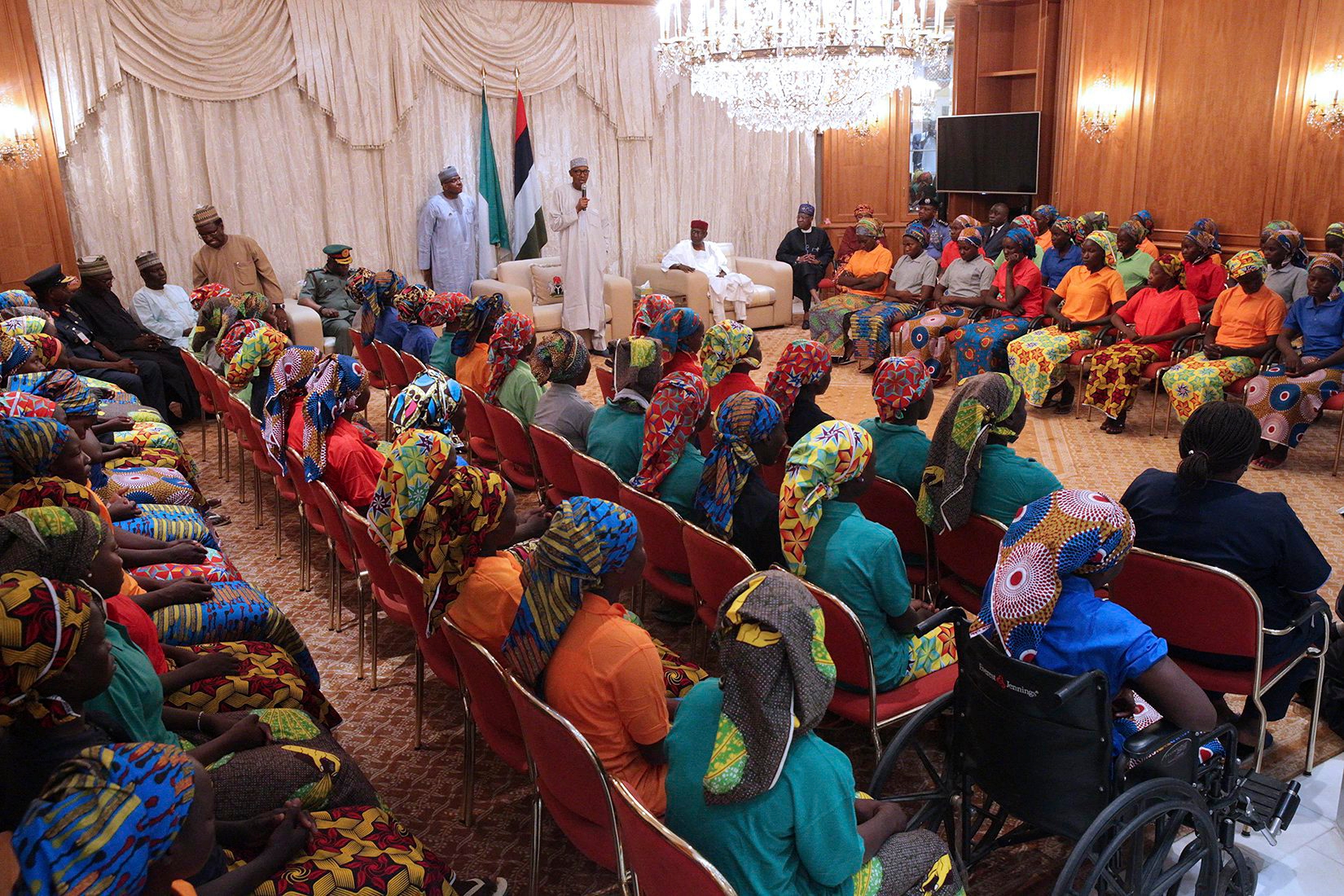 In this photo released by the Nigeria State House, Nigeria's President, Muhammadu Buhari, centre, meets with Chibok school girls recently freed from Nigeria Extremist captivity in Abuja, Nigeria, Sunday, May. 7, 2017. Five Boko Haram commanders were released in exchange for the freedom of 82 Chibok schoolgirls kidnapped by the extremist group three years ago, a Nigerian government official said Sunday, as the girls were expected to meet with the country's president and their families. (Bayo Omoboriowo/Nigeria State House via AP) Nigeria Kidnapped Girls