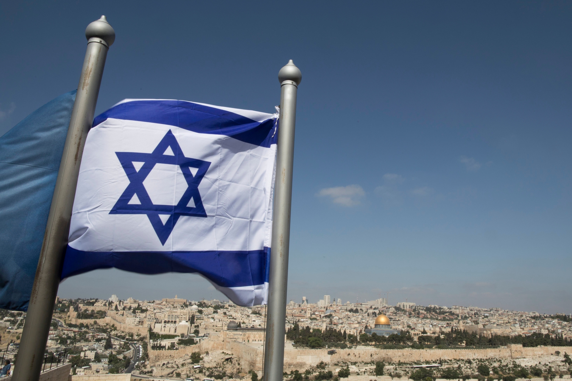 epa05941525 An Israeli flag is raised on the Mount of Olives with the Old City in the background in Jerusalem, Israel, 03 May 2017. According to reports, United Nations Educational, Scientific and Cultural Organization (UNESCO) executive board on 02 May passed a resolution calling Israel 'occupying power' in Jerusalem and criticizing measures and actions taken by Israel as 'null and void'. The resolution denounced excavations and tunneling in East Jerusalem, particularly in and around the Old City. Israel condemned the resolution which was passed on Israelís Independence Day.  EPA/ABIR SULTAN ISRAEL UNESCO JERUSALEM RESOLUTION