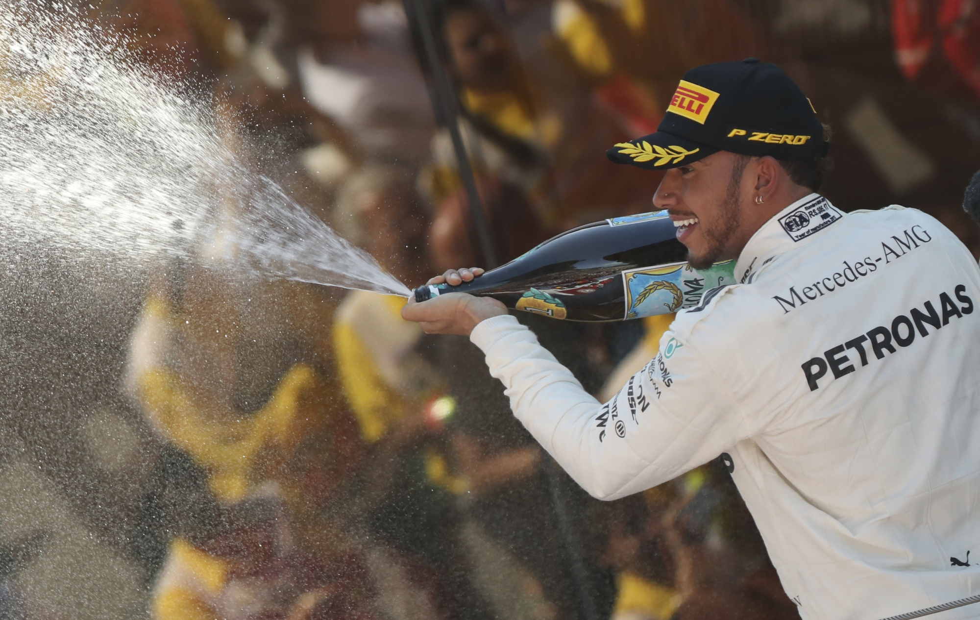 Mercedes driver Lewis Hamilton of Britain celebrates on the podium after winning the Spanish Formula One Grand Prix at the Barcelona Catalunya racetrack in Montmelo, Spain, Sunday, May 14, 2017. (AP Photo/Emilio Morenatti)