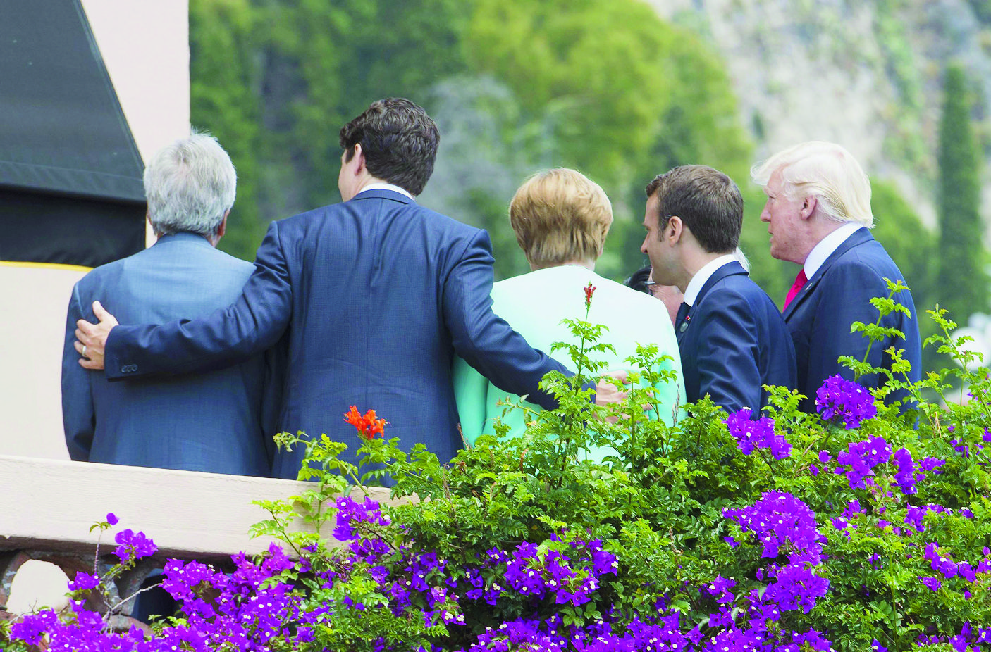 epa05992882 A handout photo made available by the Chigi Palace Press office on 27 May 2017 shows part of the G7 leaders with (L-R) Italian Prime Minister Paolo Gentiloni, Canadian Prime Minister Justin Trudeau, German Chancellor Angela Markel, French President Emmanuel Macron and US President Donald J. Trump  posing for a group photo during the G7 Summit extended session in the Sicilian town of Taormina, Italy, on its second day on 27 May 2017. The second day is scheduled to deal with Innovation and Development in Africa, Global Issues such as Human Mobility, Food Security and Gender Equality as well as the G7 Global Relations,  the Italian G7 Presidency said in a media release.  EPA/TIBERIO BARCHIELLI/CHIGI PRESS OFFICE HANDOUT  HANDOUT EDITORIAL USE ONLY/NO SALES ITALY G7 SUMMIT