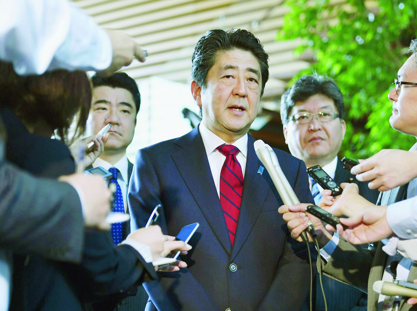 Japanese Prime Minister Shinzo Abe, center, answers to a reporter's question about North Korea's missile launch, at his official residence in Tokyo Monday morning, May 29, 2017. North Korea on Monday fired an apparent ballistic missile off its east coast that landed in the waters of Japan's economic zone, South Korean and Japanese officials said, the latest in a string of recent test launches as the North seeks to build nuclear-tipped ICBMs that can reach the U.S. mainland. (Muneyuki Tomari/Kyodo News via AP) Japan Koreas Tensions