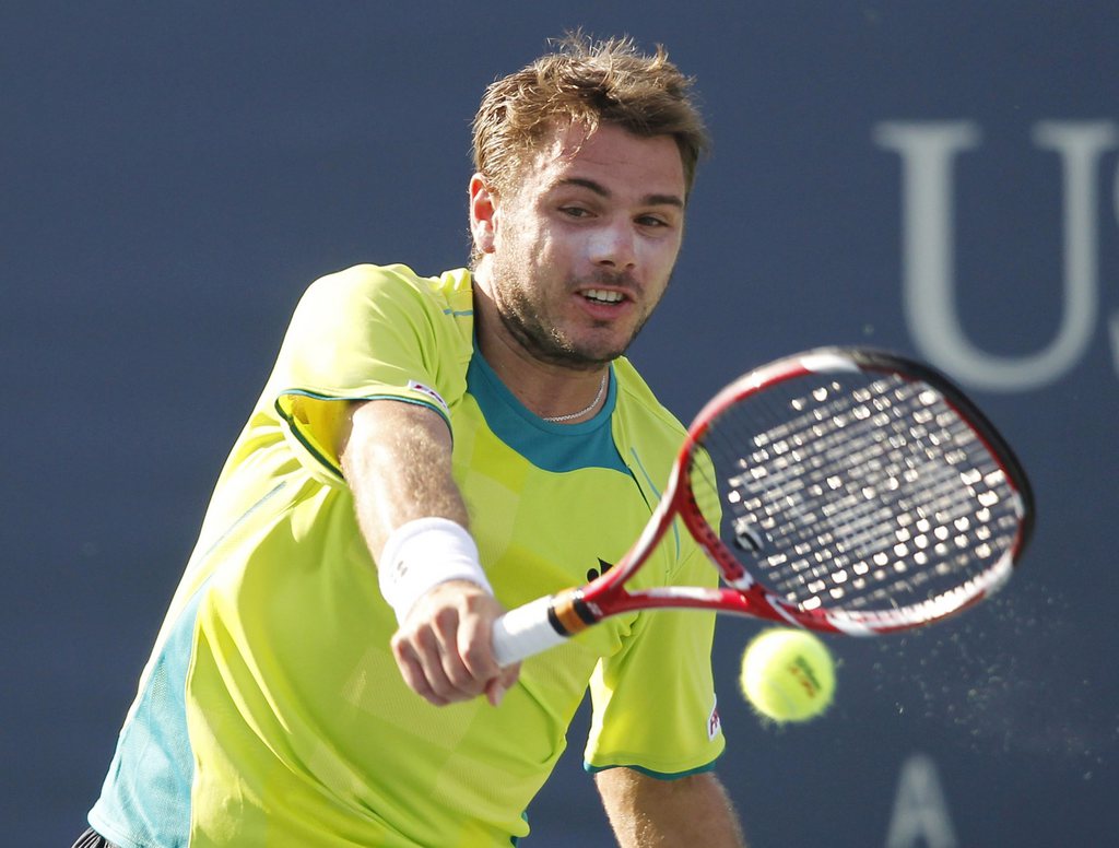 Switzerland's Stanislas Wawrinka returns a shot to Ukraine's Sergiy Stakhovsky in the first round of play at the 2012 US Open tennis tournament, Tuesday, Aug. 28, 2012, in New York. (AP Photo/Mel C. Evans)