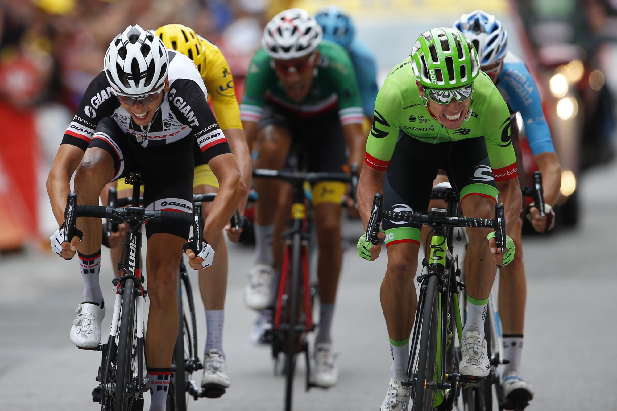 Colombia's Rigoberto Uran, right, crosses the finish line ahead of ahead of France's Warren Barguil, left, to win the ninth stage of the Tour de France cycling race over 181.5 kilometers (112.8 miles) with start in Nantua and finish in Chambery, France, Sunday, July 9, 2017. (AP Photo/Peter Dejong)