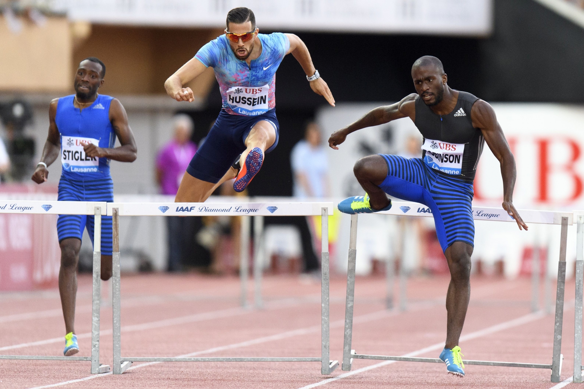 Michael Stigler from the USA, Kariem Hussein from Switzerland and Byron Robinson from the USA, from left, compete in the men's 400m hurdles race at the Athletissima IAAF Diamond League international athletics meeting in the Stade Olympique de la Pontaise in Lausanne, Switzerland, Thursday, July 6, 2017. (KEYSTONE/Jean-Christophe Bott)