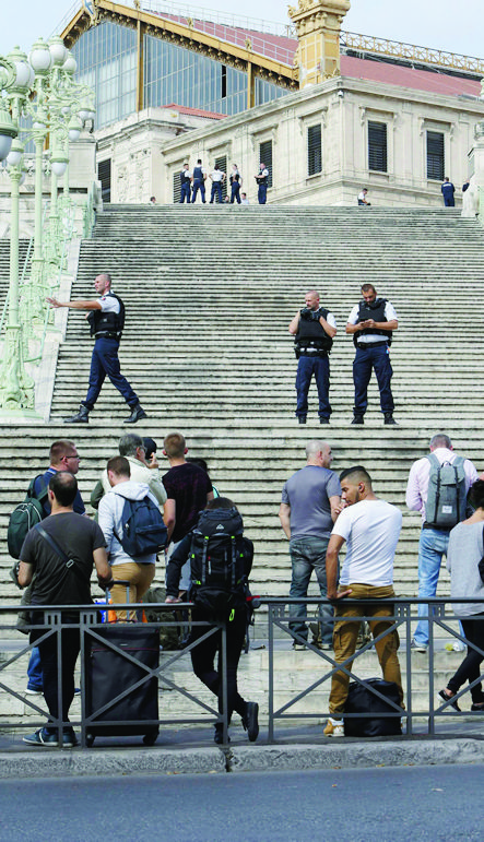 French police officers block access on the stairs leading to Marseille 's main train station, Sunday, Oct. 1, 2017 in Marseille, southern France. French police warn people to avoid Marseille's main train station amid reports of knife attack, assailant shot dead. (AP Photo/Claude Paris) France Knife Attack