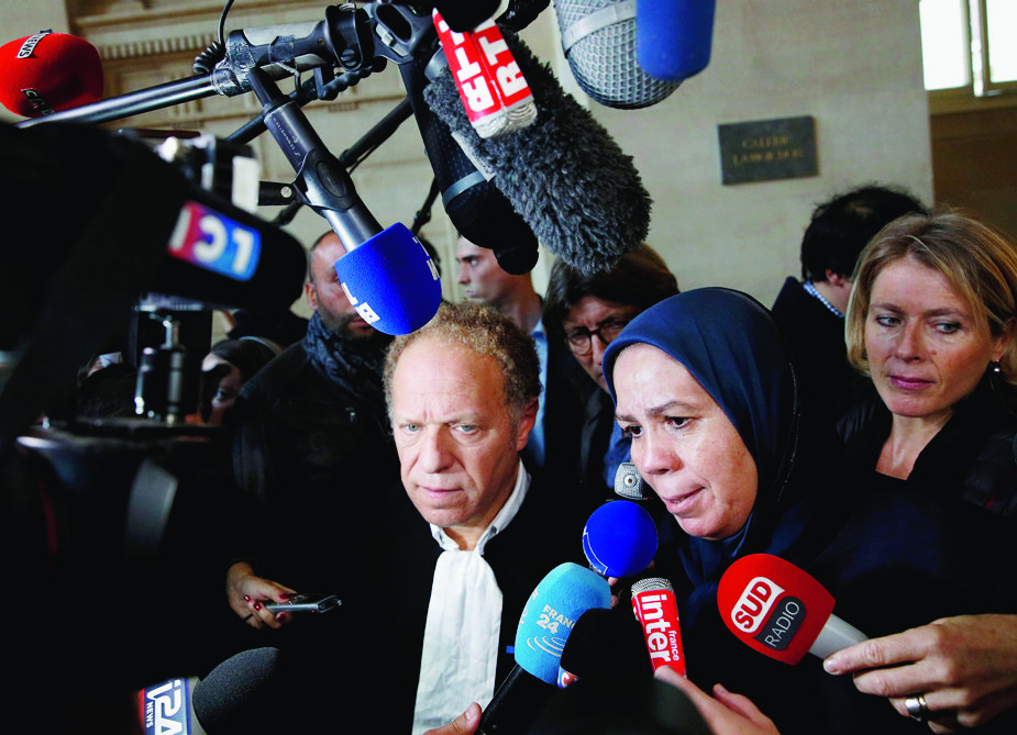 epa06239628 French-Moroccan president of the Imad Ibn Ziaten Youth Association for Peace and mother of French paratrooper Imad Ibn Ziaten, victim of jihadist Mohammed Merah, Latifa Ibn Ziaten (C), flanked by her lawyer Mehana Mouhou (L), speaks to media as they arrive to the Paris Court for the trial of Abdelkader Merah, suspected of helping his brother to plan the 2012 attacks, in Paris, France, 02 October 2017. Mohammed Merah killed children and a rabbi in March 2012 at a 'Ozar Hatorah' Jewish school, as well as three French soldiers.  EPA/YOAN VALAT FRANCE TERROR TRIAL