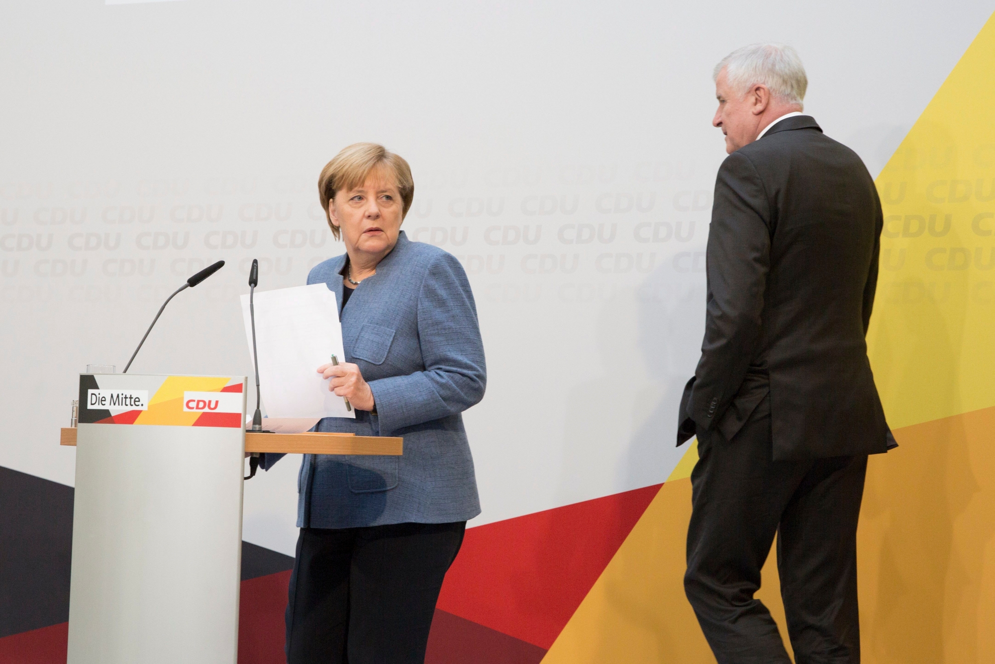 epa06254435 German Chancellor Angela Merkel of the Christian Democratic Union (CDU) during a press conference with Minister President of Bavaria Horst Seehofer (R) of the The Christian Social Union in Bavaria (CSU) party during a press conference at the Konrad-Adenauer-Haus in Berlin, Germany, 09 October 2017. German Chancellor Merkel said on the press conference that she invites the Free Democratic Party (FDP) and The Greens to start exploratory talks on coalition negotiations building a new federal Government in Germany on 18 October 2017.  EPA/OMER MESSINGER GERMANY ELECTIONS 2017