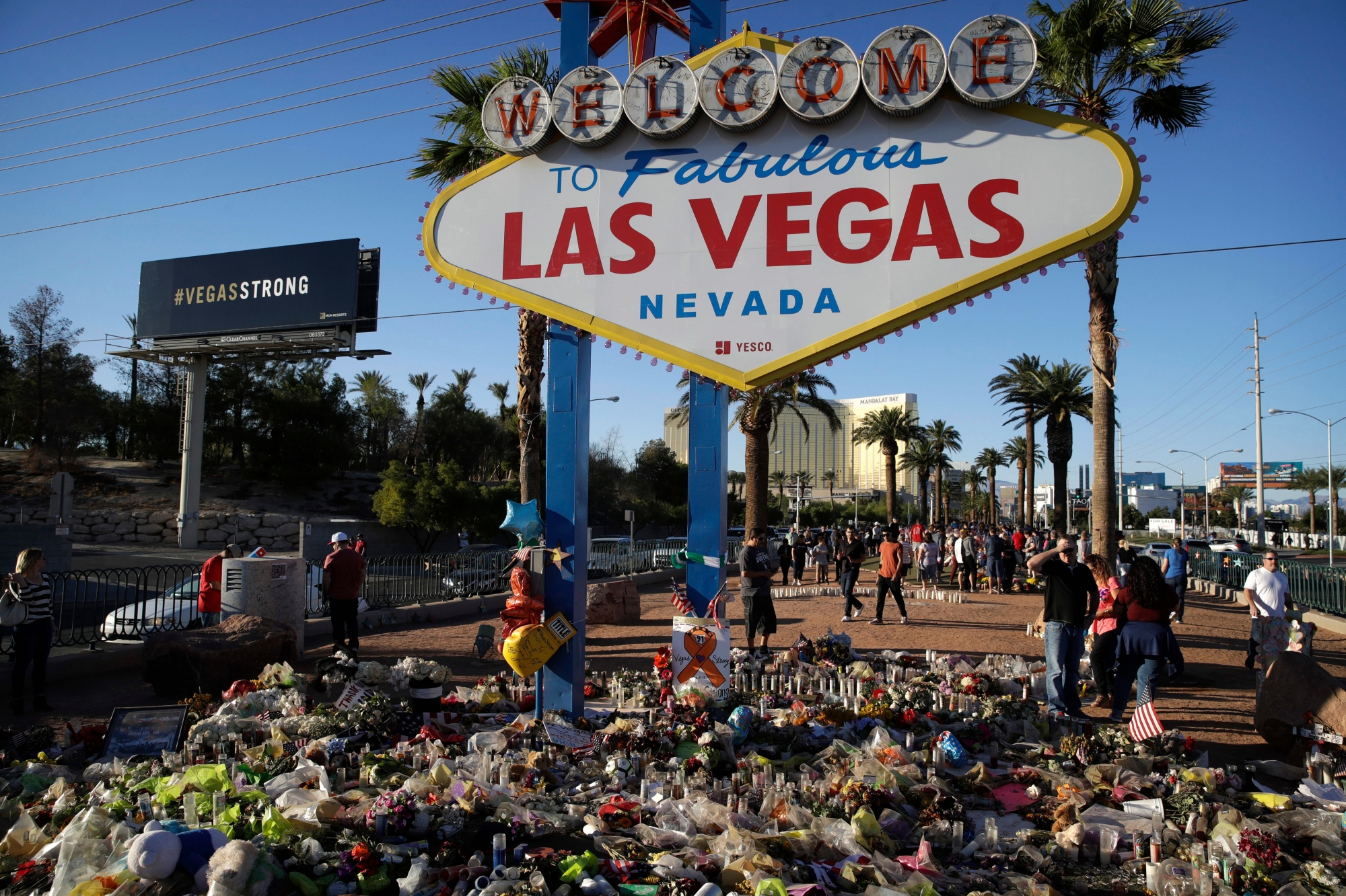 Flowers, candles and other items surround the famous Las Vegas sign at a makeshift memorial for victims of a mass shooting Monday, Oct. 9, 2017, in Las Vegas. Stephen Paddock opened fire on an outdoor country music concert killing dozens and injuring hundreds. (AP Photo/John Locher) Las Vegas Shooting