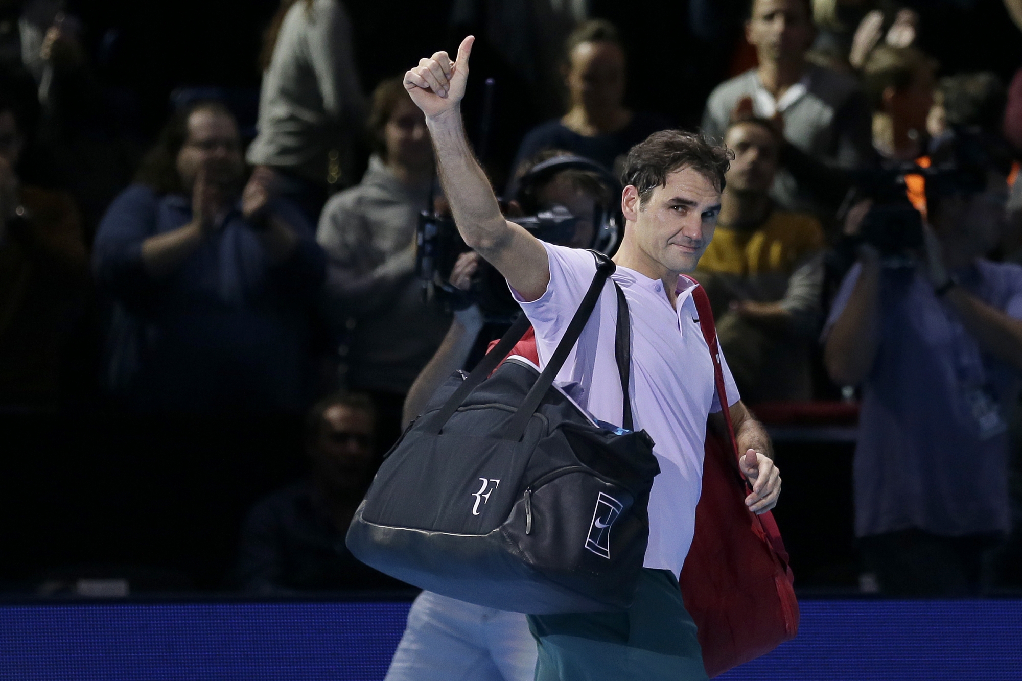 Roger Federer of Switzerland walks off the court after losing to David Goffin of Belgium in their ATP World Tour Finals semifinal tennis match at the O2 Arena in London, Saturday Nov. 18, 2017. (AP Photo/Tim Ireland)