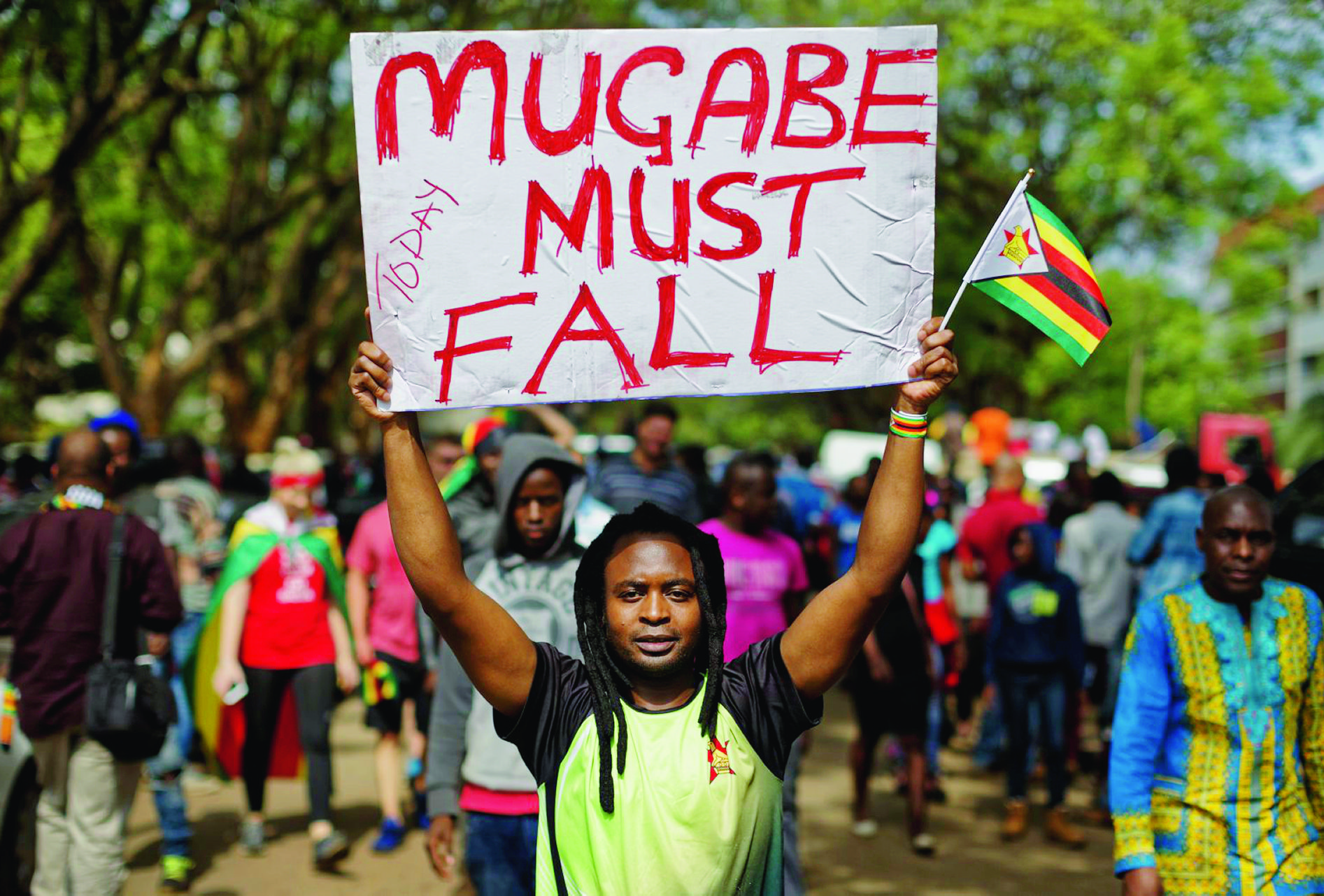 Protesters demanding President Robert Mugabe stands down march towards State House in Harare, Zimbabwe Saturday, Nov. 18, 2017. In a euphoric gathering that just days ago would have drawn a police crackdown, crowds marched through Zimbabwe's capital on Saturday to demand the departure of President Robert Mugabe, one of Africa's last remaining liberation leaders, after nearly four decades in power. (AP Photo/Ben Curtis) Zimbabwe Political Turmoil