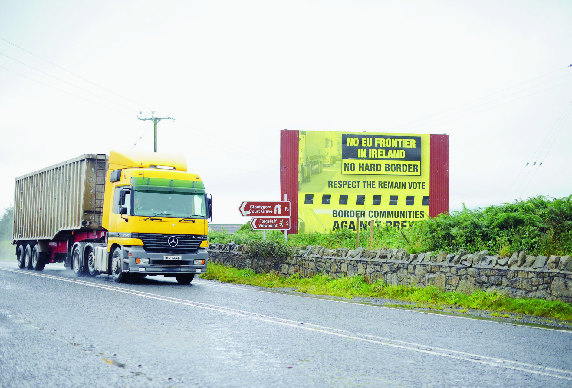 epa06154742 A truck passes a sign calling for not returning to hard border crossings after Brexit near Killeen, Northern Ireland, Britain, 21 August 2017, near the border with The Republic of Ireland. Britainís decision to leave the EU means that the current open border policy is a problem that the politicians are trying to resolve before Brexit in 2019.  EPA/AIDAN CRAWLEY BRITAIN NORTHERN IRELAND IRELAND BORDER
