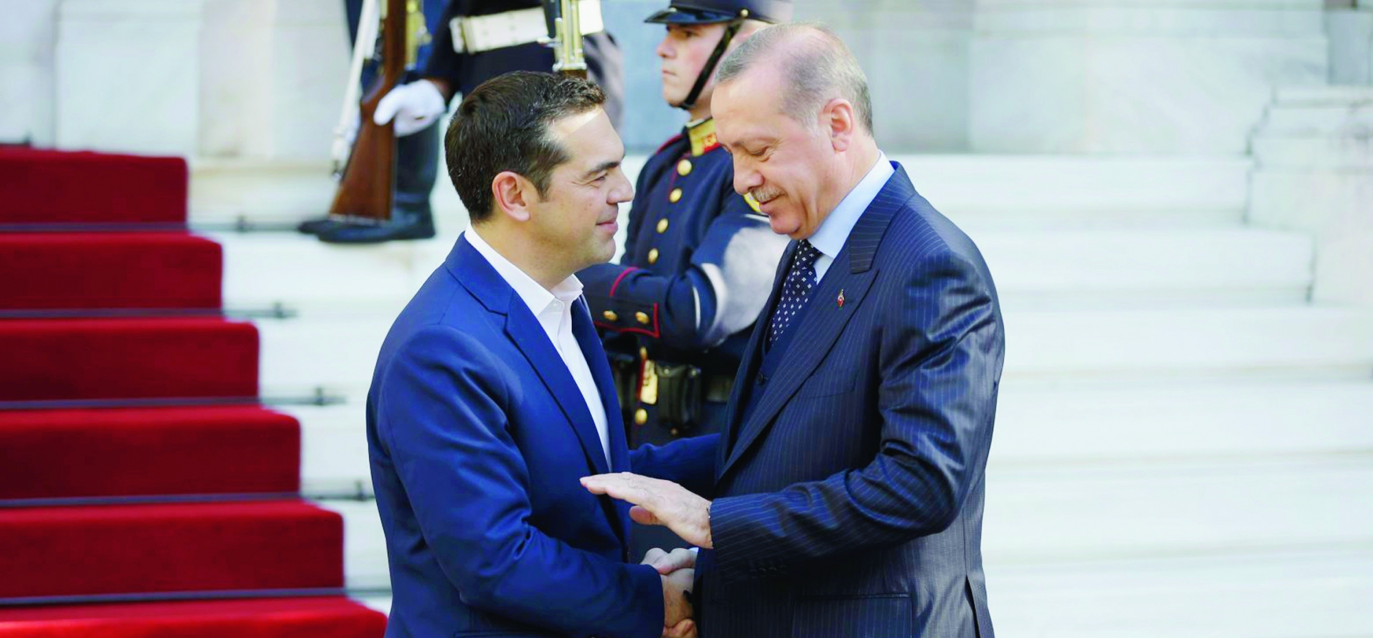 Greece's Prime minister Alexis Tsipras, left, shakes hands with Turkey's President Recep Tayyip Erdogan, right, as he welcomes him at his office in Athens, Thursday, Dec. 7, 2017. Erdogan arrived in Athens Thursday for a two-day official visit, the first official visit by a Turkish president in decades, with Greece hoping the trip will help improve often frosty ties with its neighbour. (AP Photo/Thanassis Stavrakis) Greece Turkey Erdogan