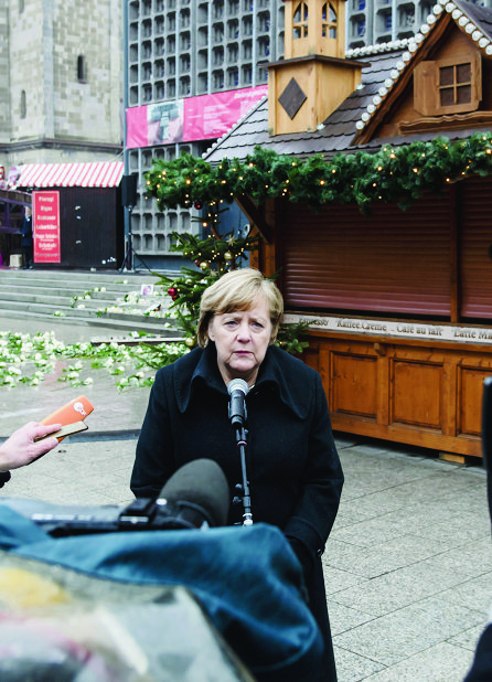 epa06398884 German Chancellor Angela Merkel gives a press statement after the commemorative events marking the first anniversary of the terrorist attack on Christmas market at Breitscheidplatz in Berlin, Germany, 19 December 2017. The Breitscheidplatz square in Berlin on the same day in 2016 was the target of a terror attack in which 12 people lost their lives and around 50 others were injured, when a truck driven by Anis Amri plowed through the Christmas market.  EPA/CLEMENS BILAN GERMANY CHRISTMAS MARKET TERRORISM