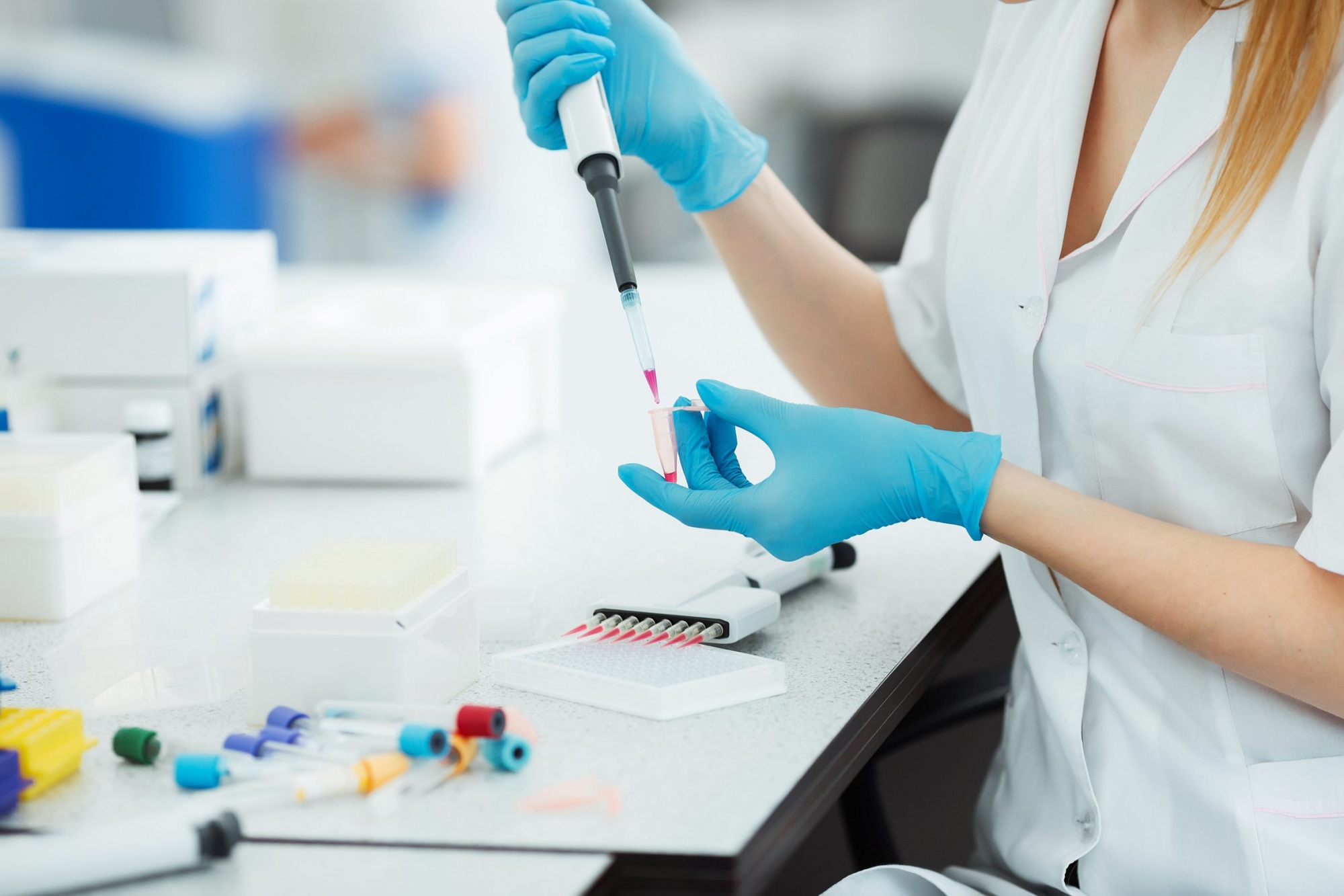 Pipette dropping a sample in a test tube. Laboratory assistant analyzing blood in lab. DNA analysis. Pipette dropping a sample in a test tube. Laboratory assistant analyzing blood in lab. DNA analysis
