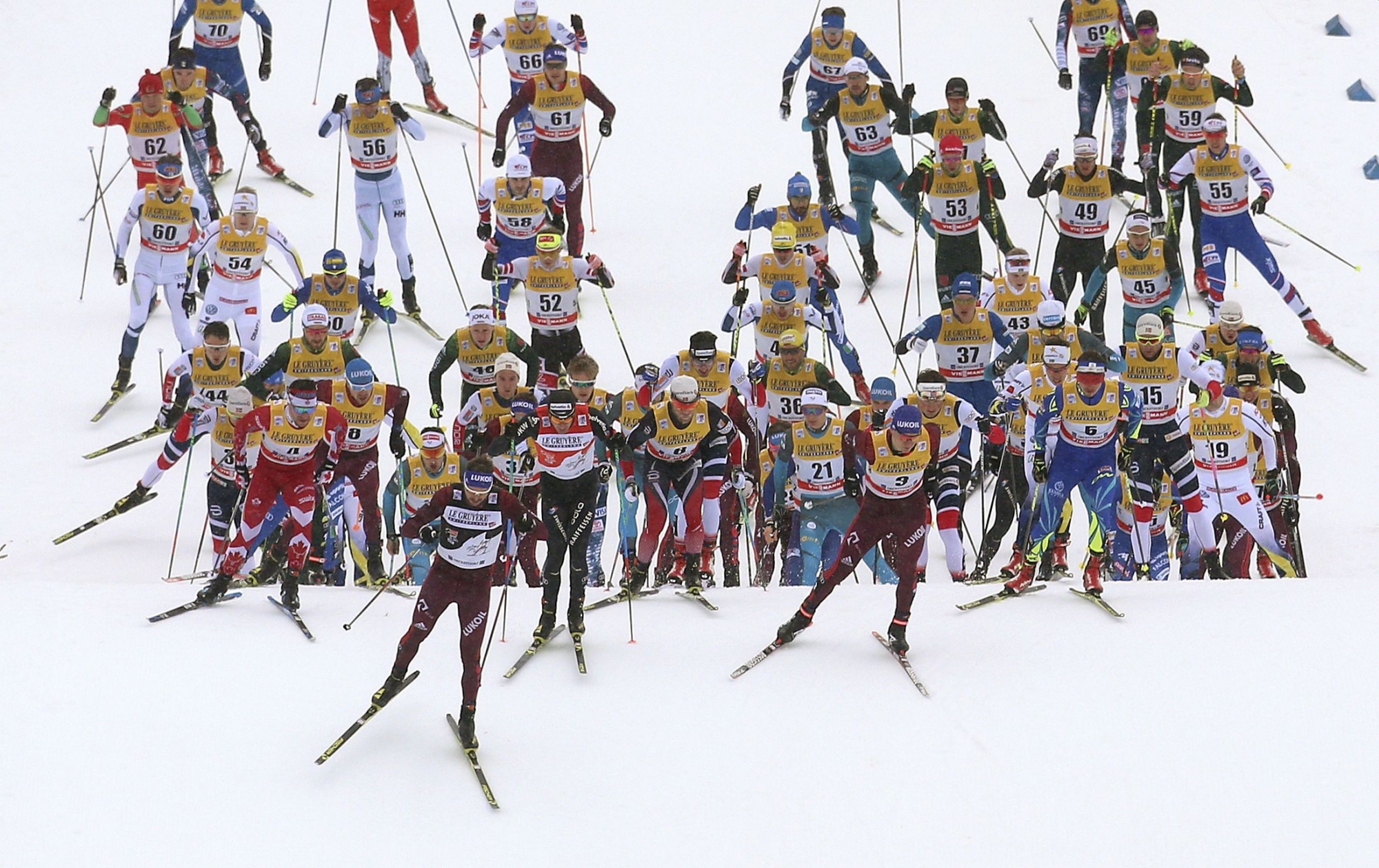 Participants with Switzerland's Dario Cologna, front row third from left, compete during the men's 15km freestyle mass start race of the Tour de Ski cross country skiing, in Oberstdorf, Germany, Thursday, Jan. 4, 2018.  (Karl-Josef Hildenbrand/dpa via AP)